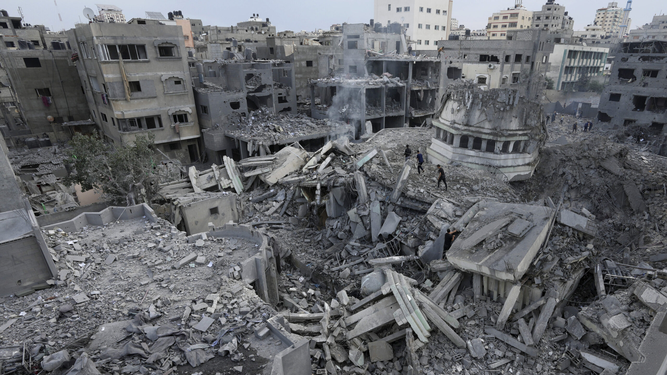 Palestinians inspect the rubble of the Yassin Mosque destroyed after it was hit by an Israeli airst...