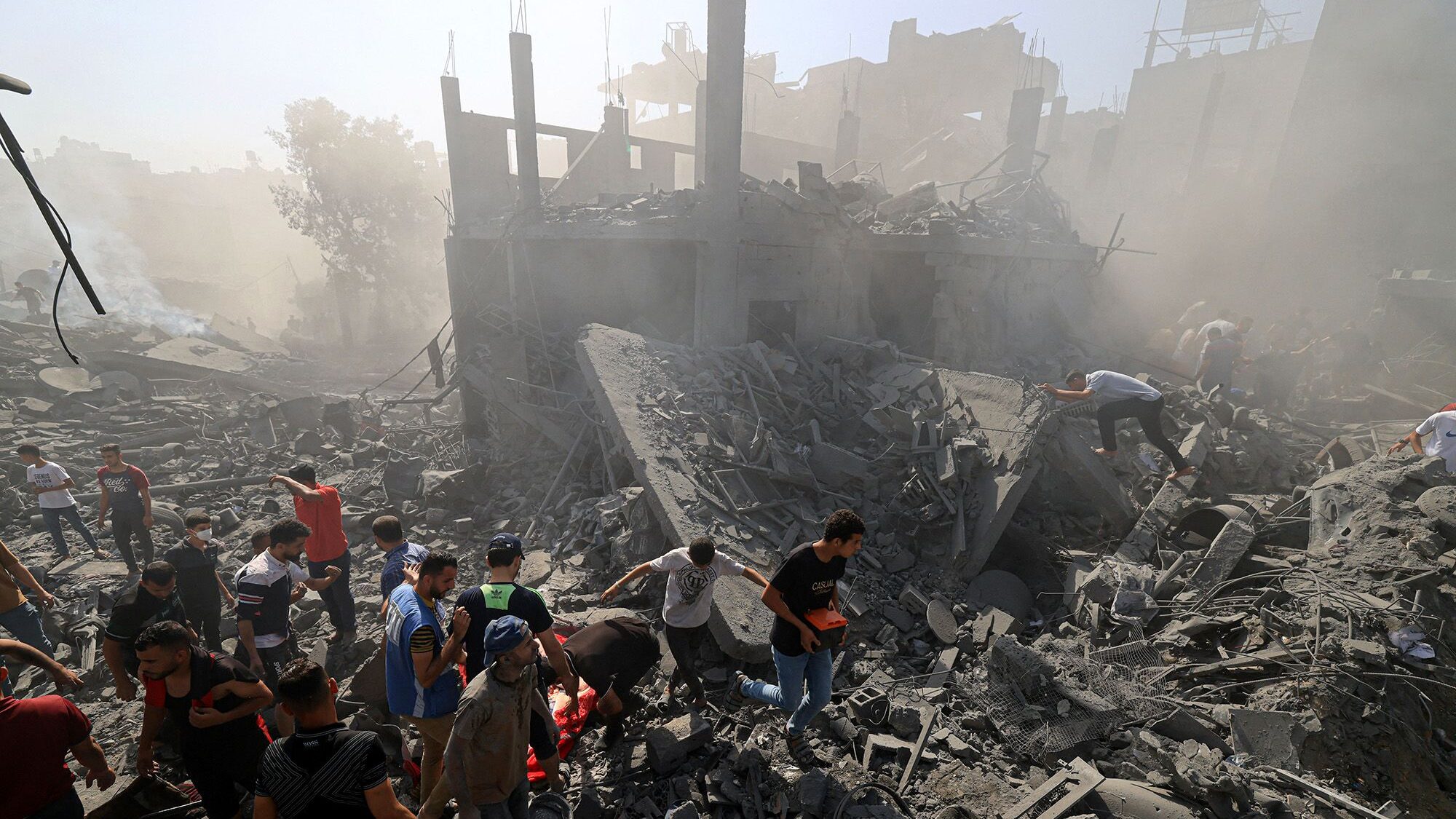 People search for survivors and the bodies of victims in the rubble of buildings destroyed during a...