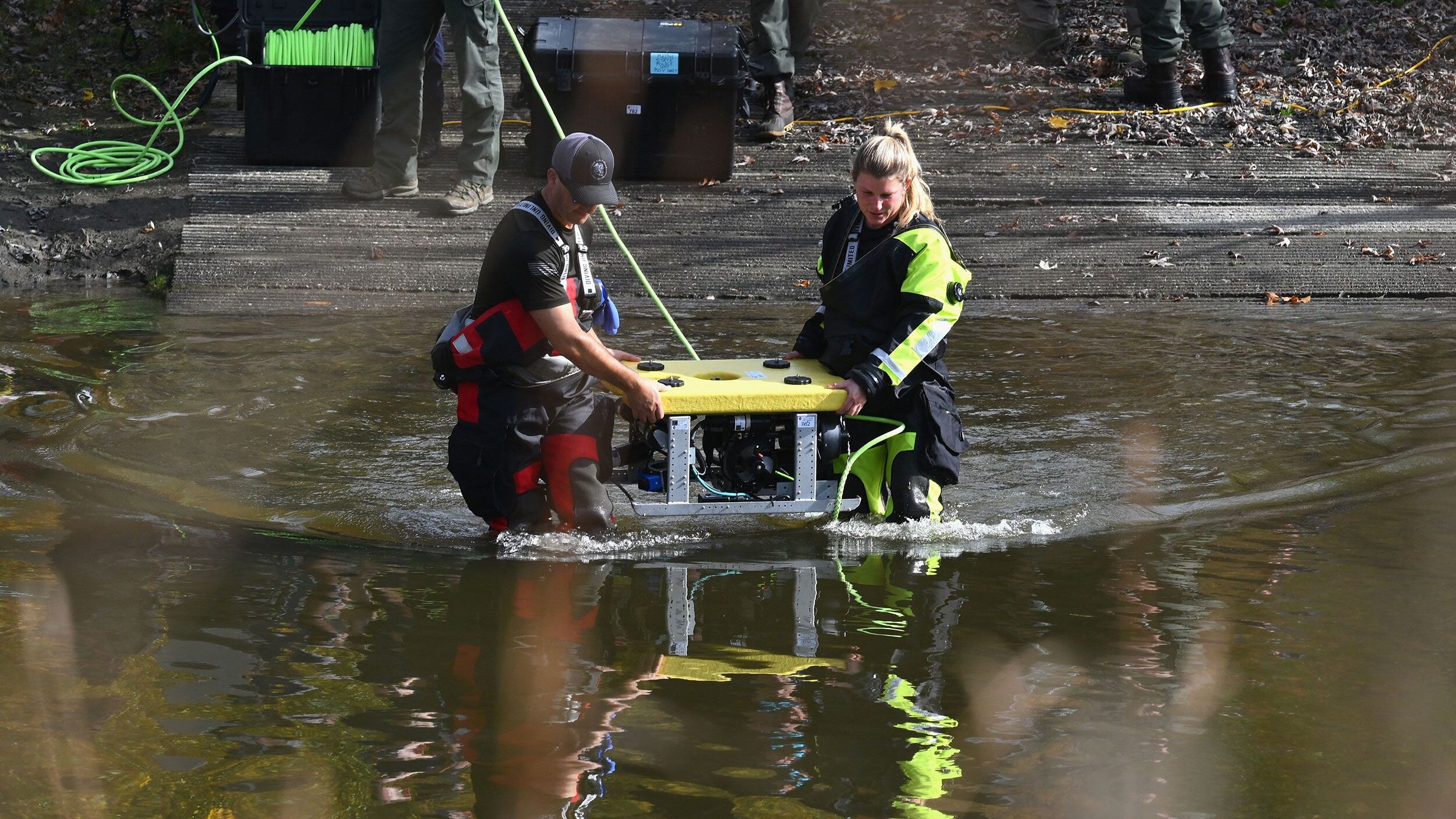 Divers prepare to search the Androscoggin River in Lisbon Falls, Maine, as investigators search for...