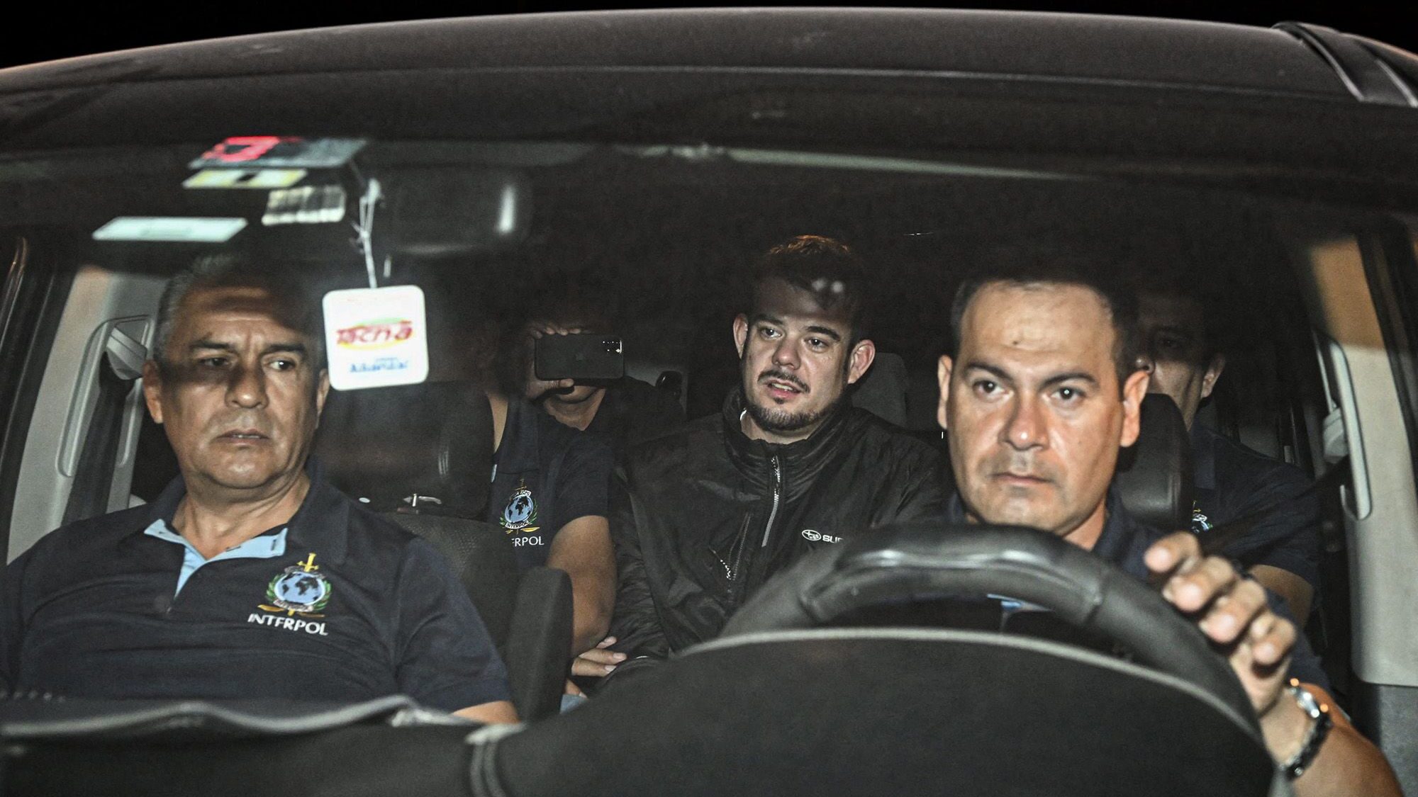 Joran van der Sloot (center) is transferred in a police car from the Ancon I jail in Lima, Peru, on...
