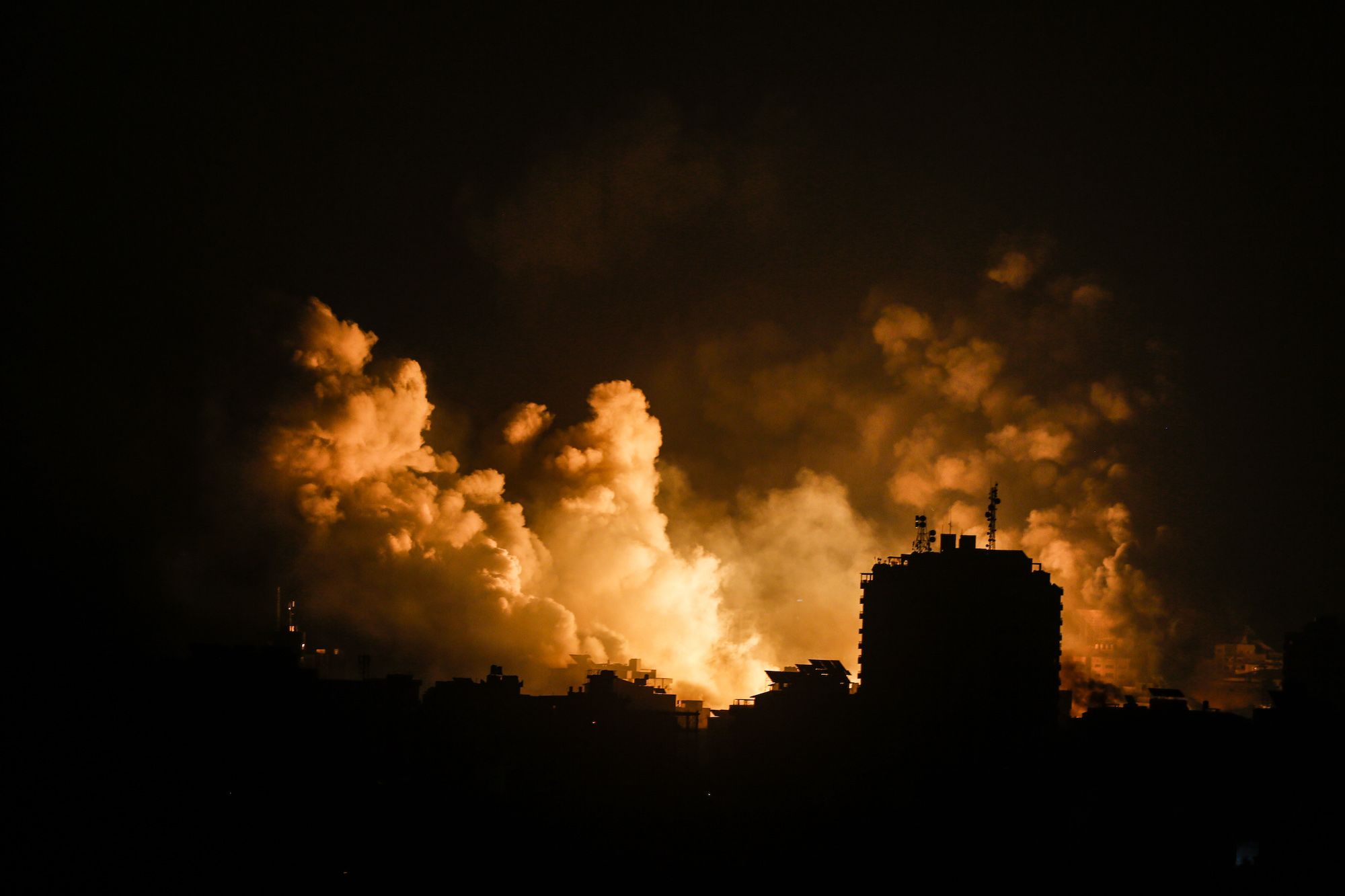 Smoke rises over buildings in Gaza City on October 9, during an Israeli air strike.
(Credit: Sameh ...