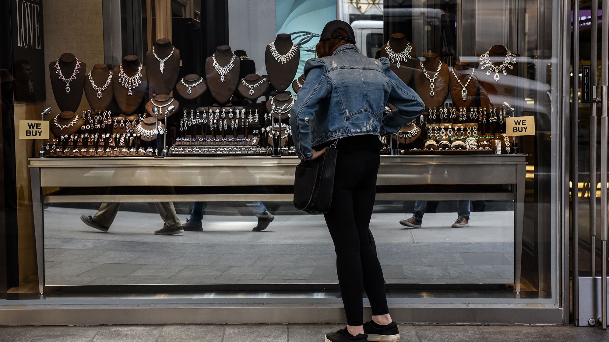 A pedestrian views diamond jewelry in the window of a store in the Diamond District neighborhood of...