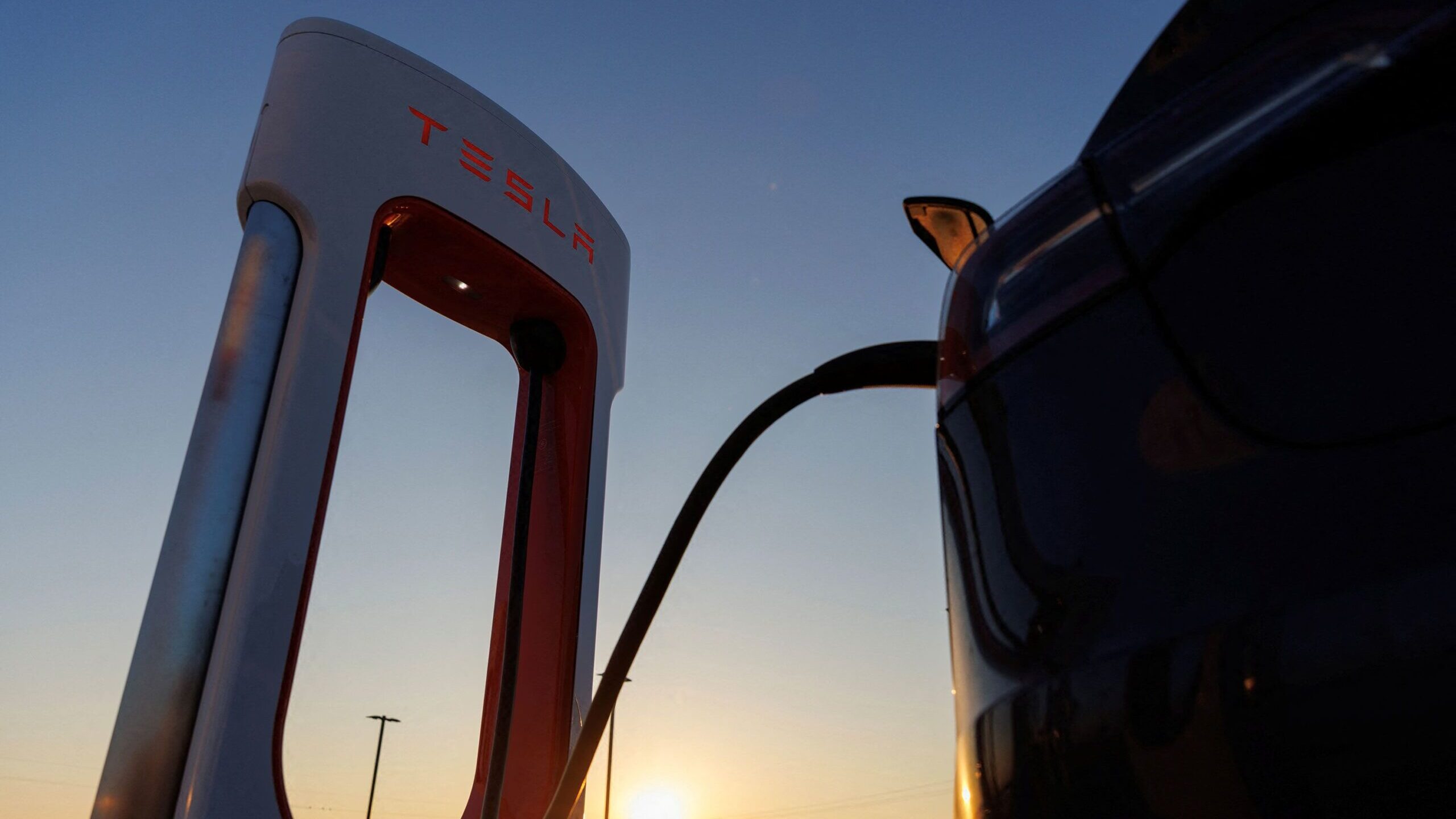 A Tesla vehicle is charged at a Tesla supercharging station in Kettleman City, California. Toyota h...