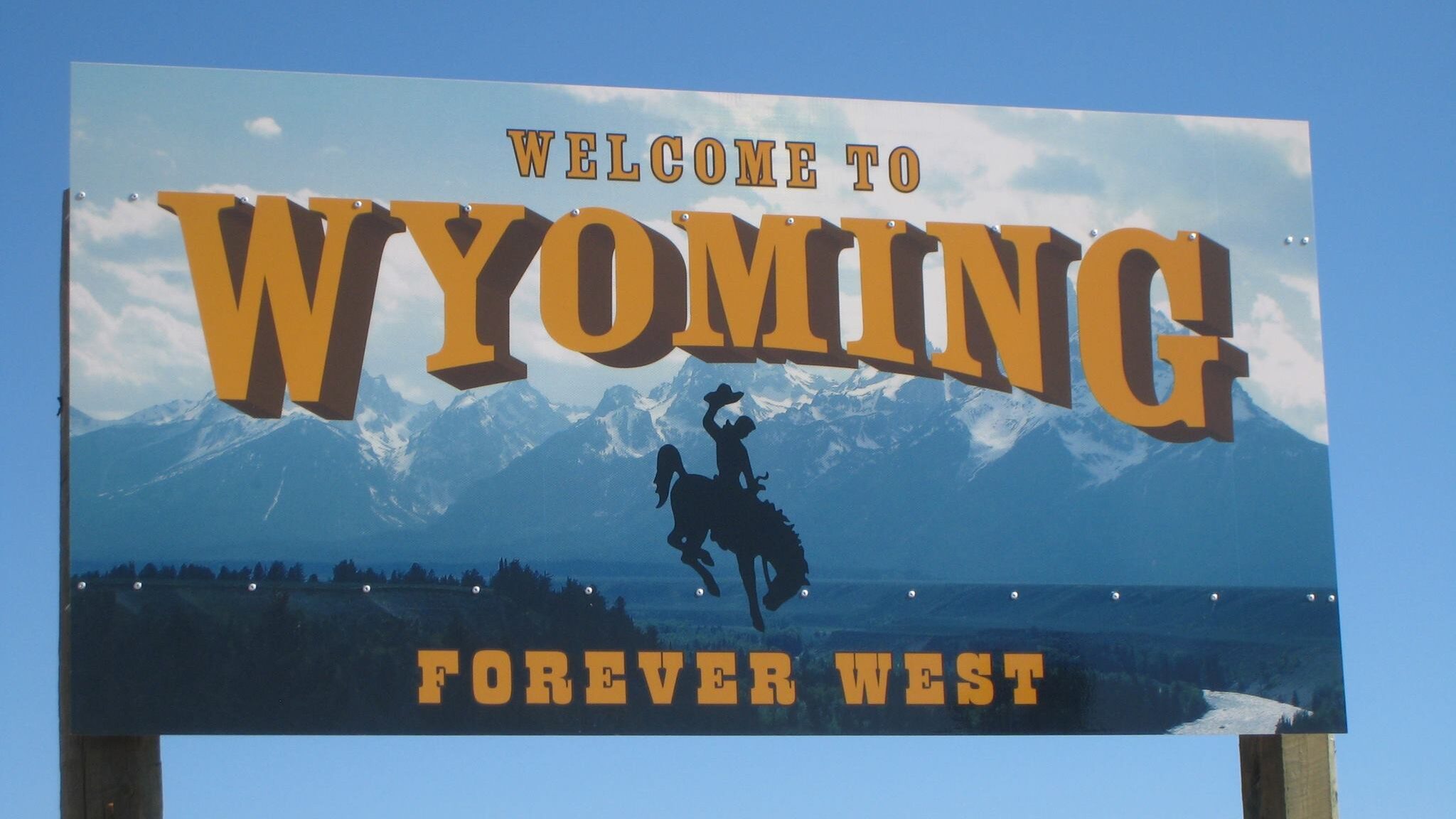 Image of a "Welcome to Wyoming" street sign. Sweetwater County and Rock Springs, Wyoming investigat...
