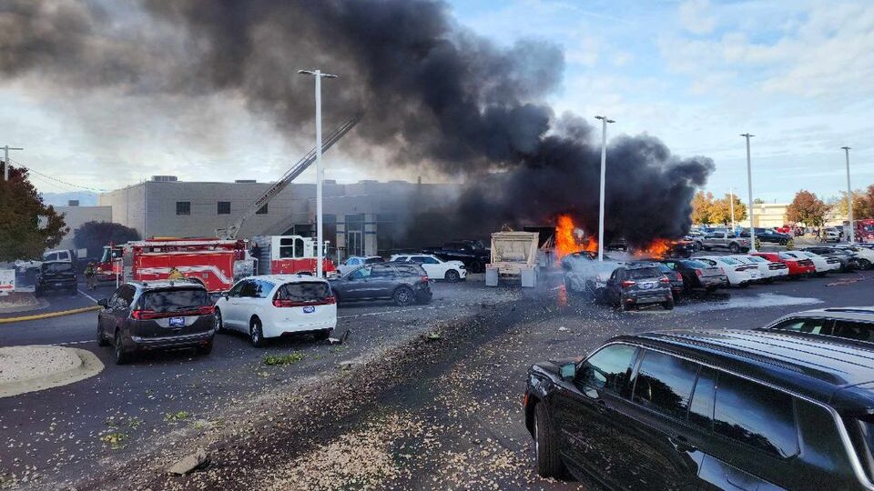 several cars are pictured next to a fire...