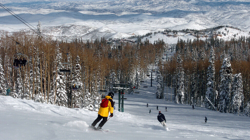 Skiers make their way down the slopes at Deer Valley Ski Resort, utah ski passes can get you more b...