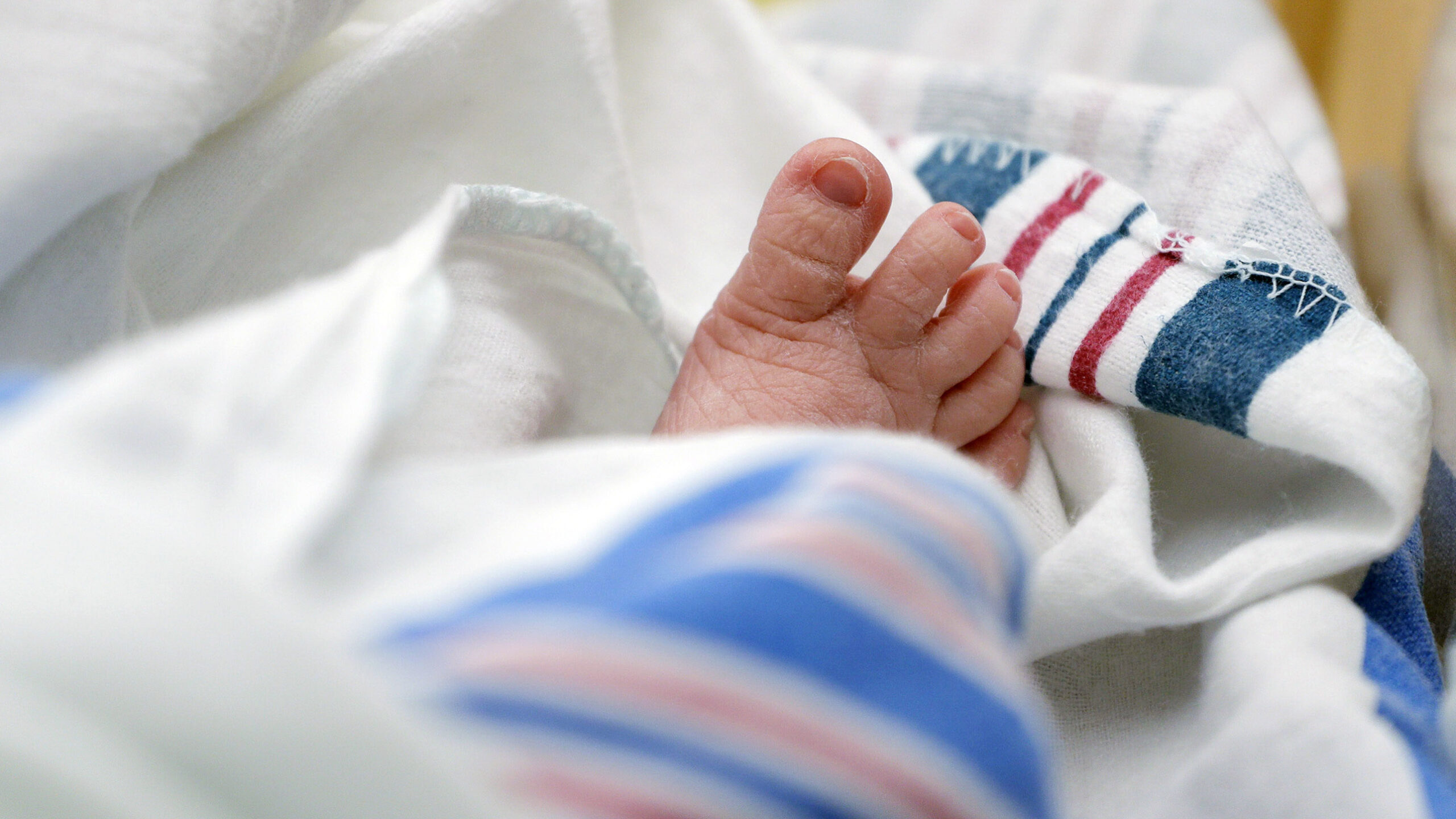 FILE - The toes of a baby peek out of a blanket at a hospital in McAllen, Texas. On Wednesday, Nov....