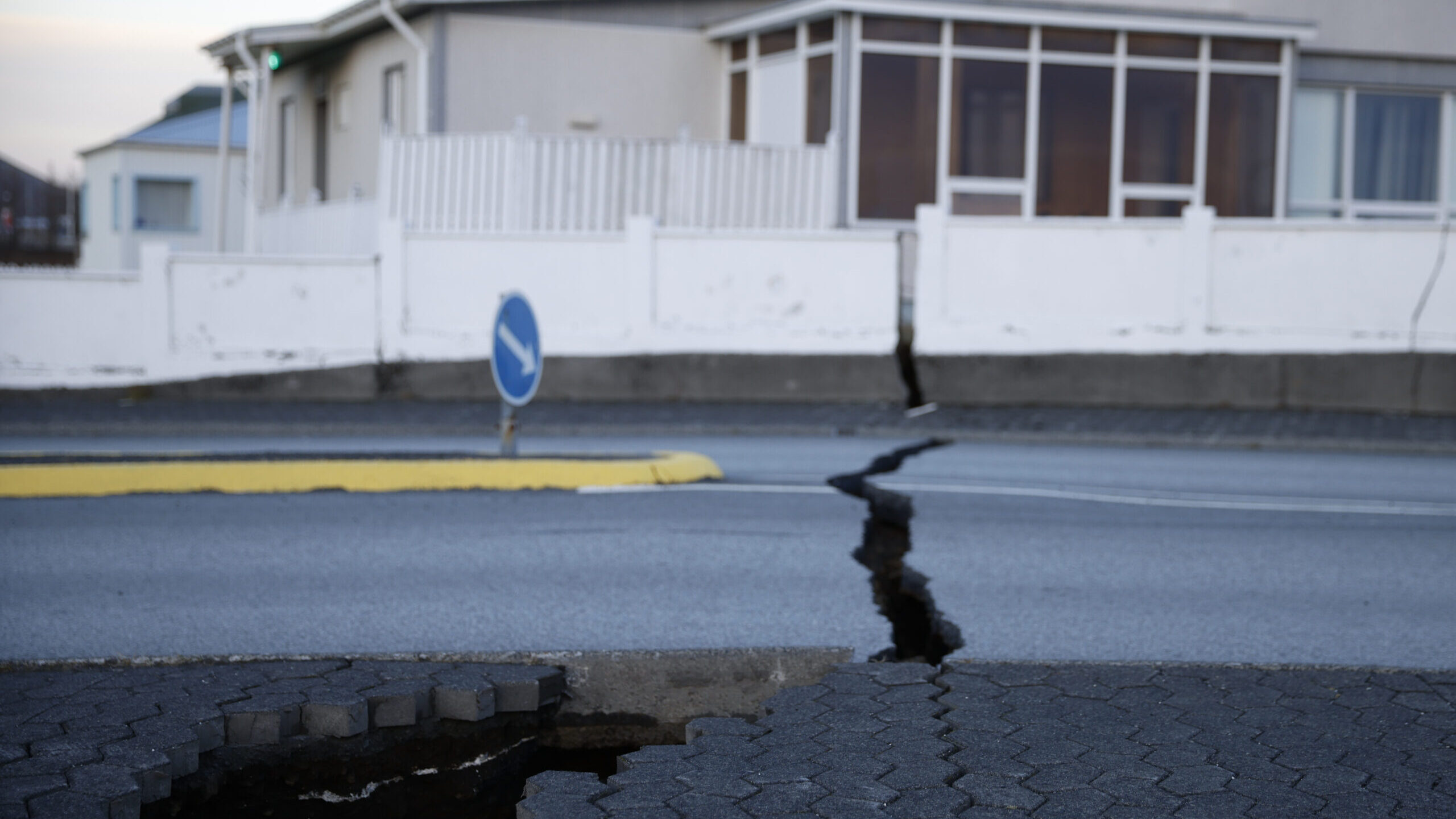 A fissure stretches across a road in the town of Grindavik, Iceland....