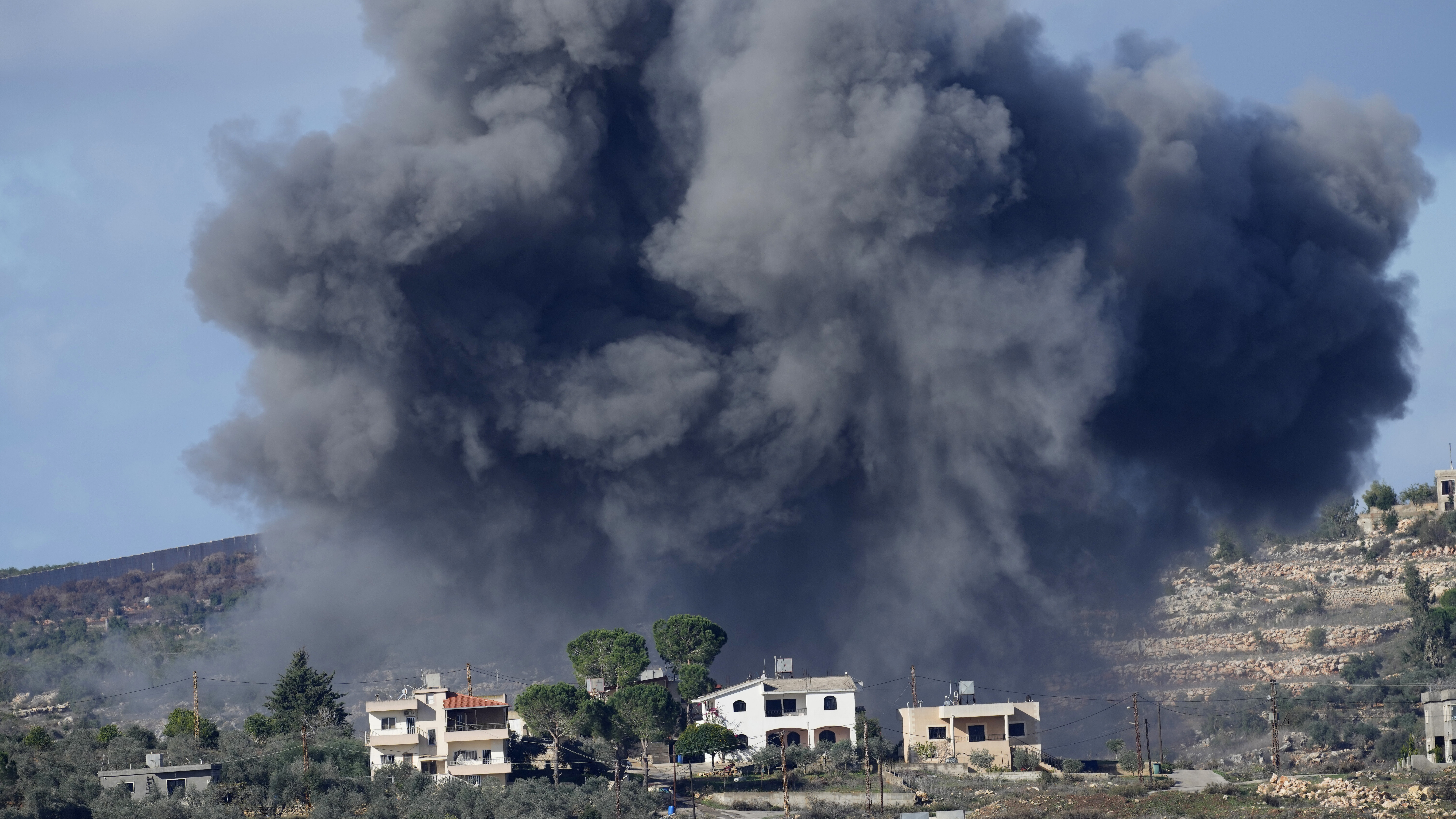 Black smoke rises from an Israeli airstrike on the outskirts of Aita al-Shaab, a Lebanese border vi...