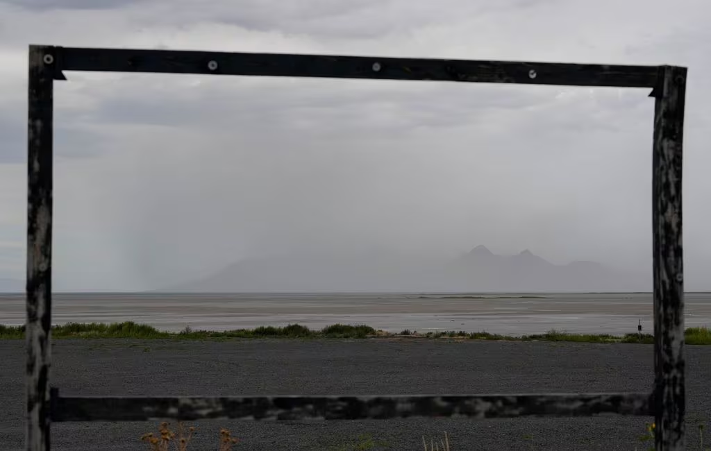 Framed by dust, strong winds blow fine particulate matter obstructing the view of Antelope Island o...