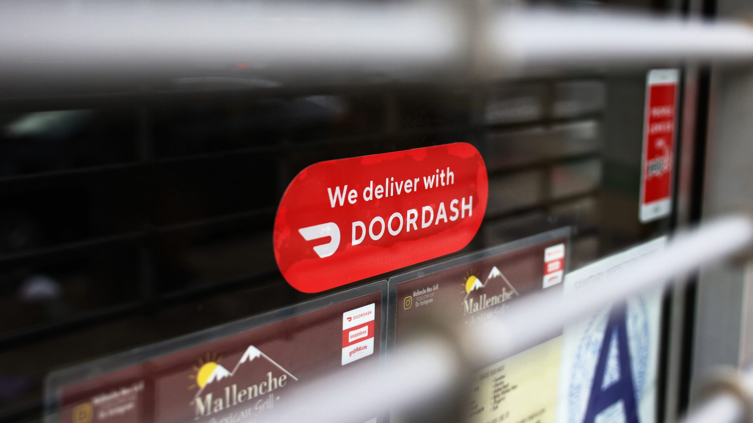 FILE: A DoorDash sticker is seen on a window at a restaurant in New York City. The food delivery co...