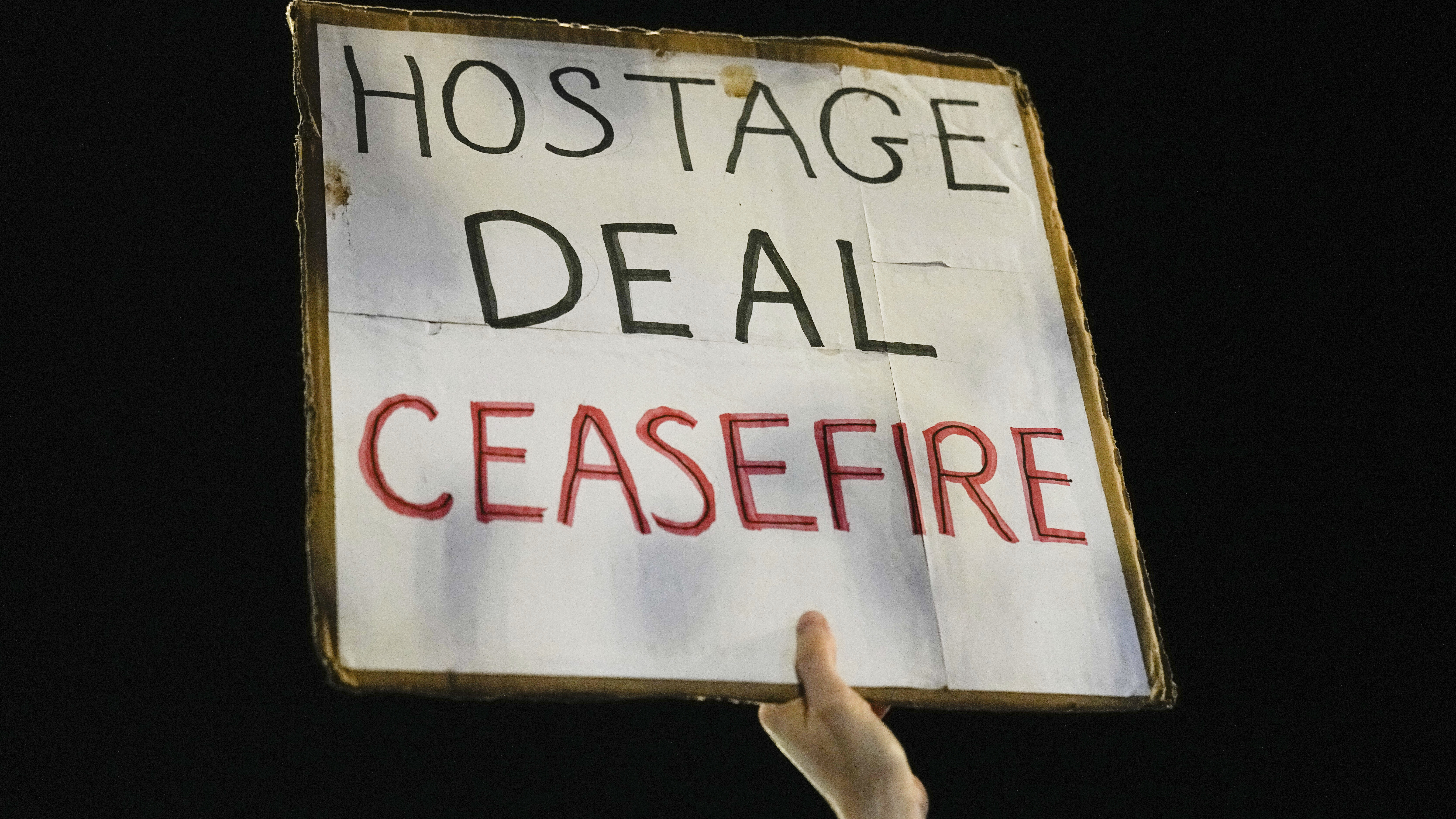 a sign says "hostage deal ceasefire"...