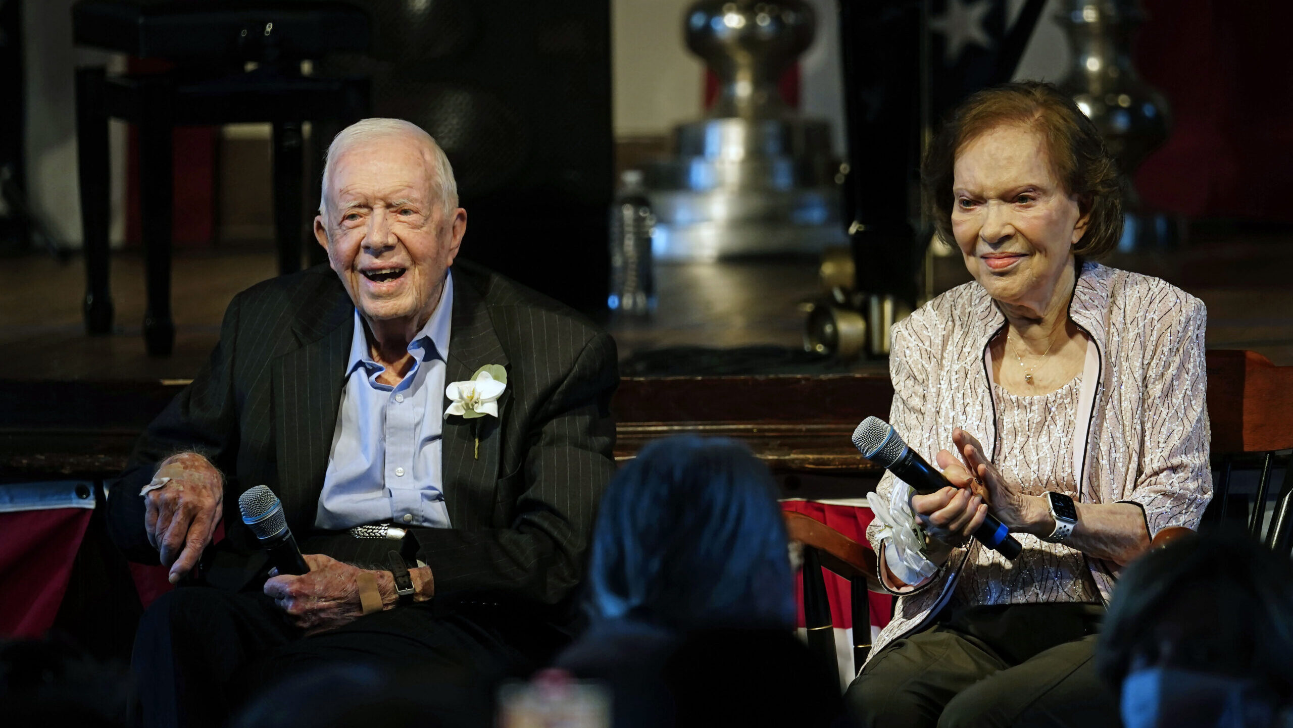 Former U.S. President Jimmy Carter and his wife, former first lady Rosalynn Carter, sit together du...