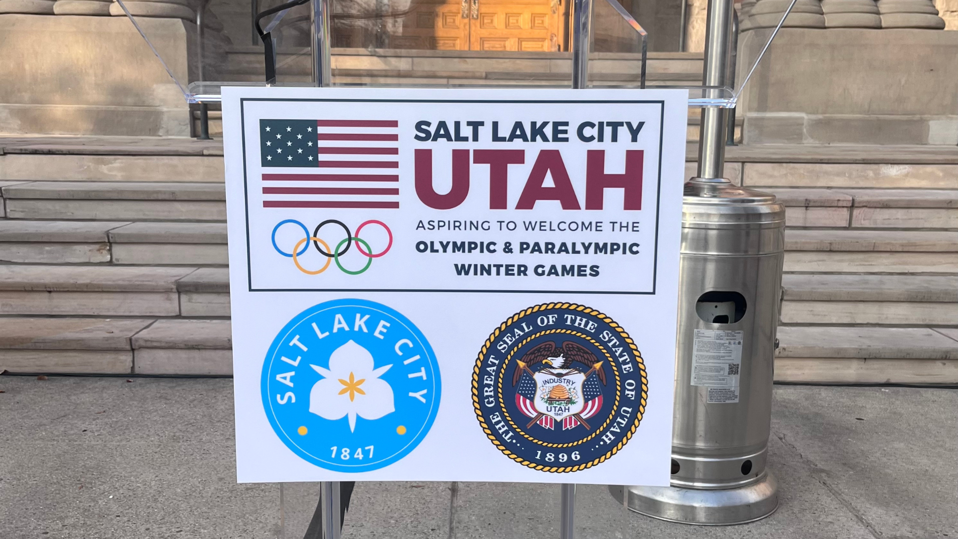 A sign placed at the Salt Lake City and County Building welcomes another chance for Salt Lake to ho...