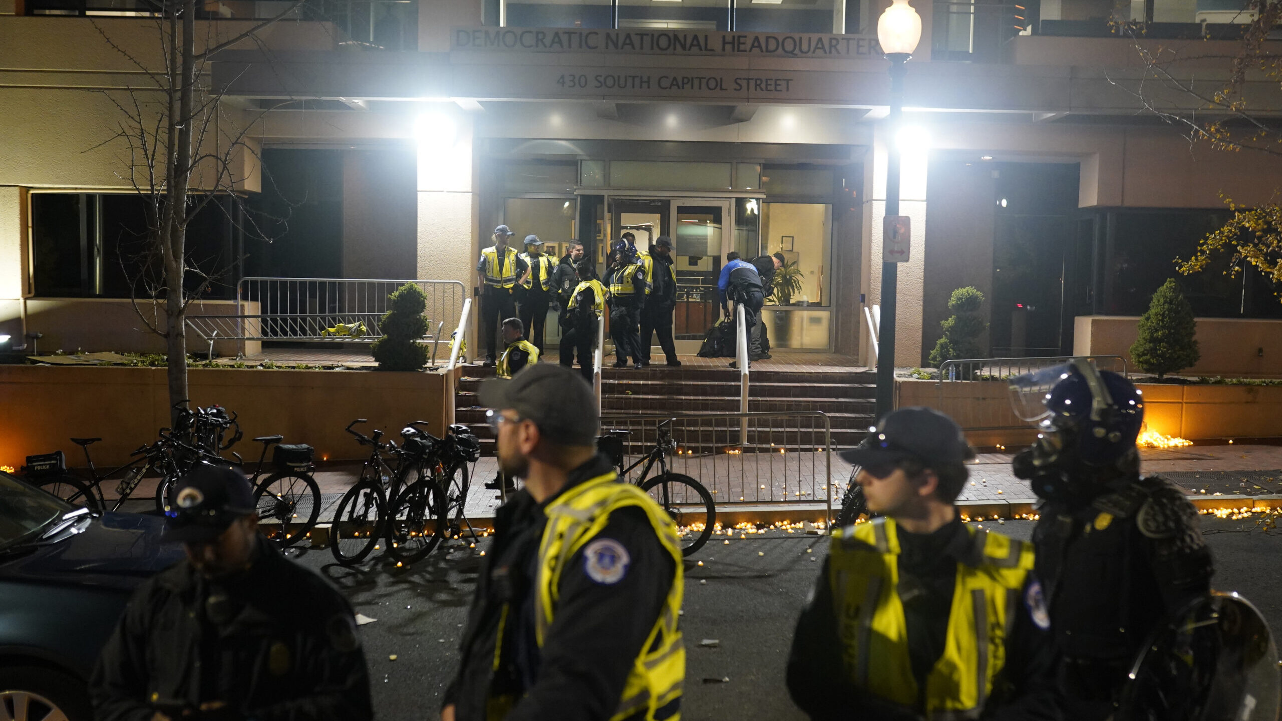U.S. Capitol Police stand outside the headquarters of the Democratic National Committee. Protesters...