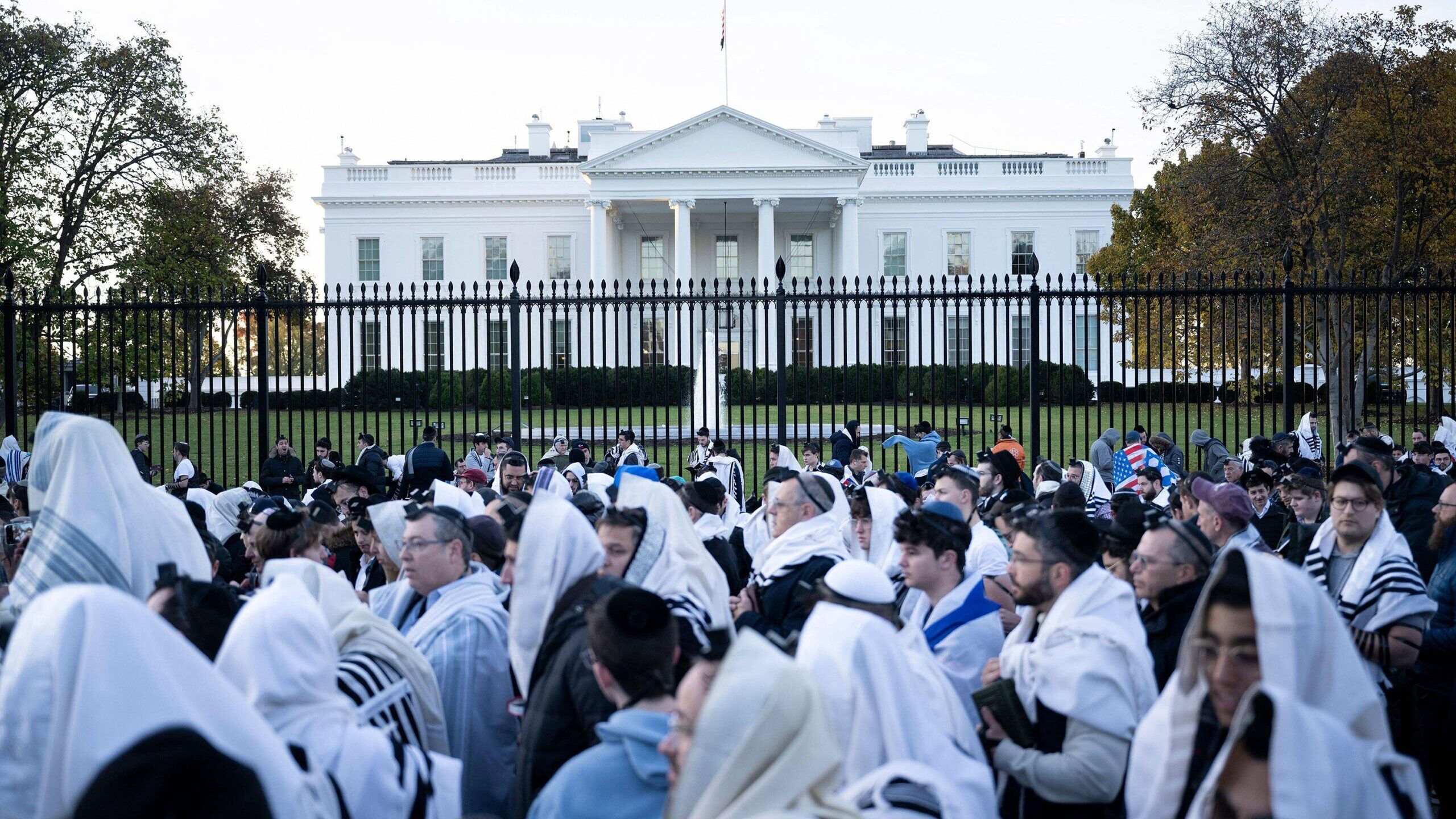 People pray on Pennsylvania Avenue in front of the White House before the 'March for Israel' rally ...