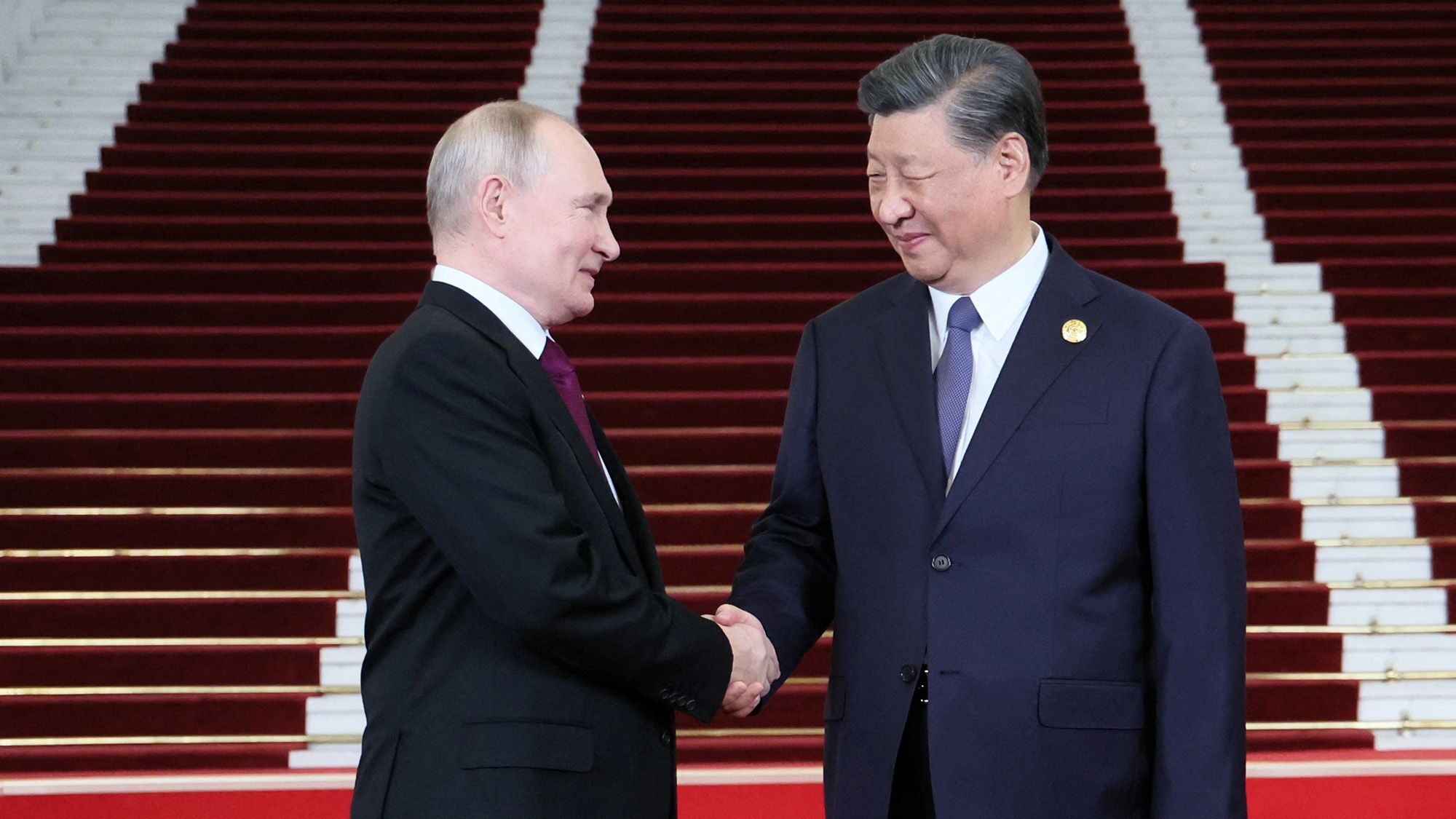 Russian President Vladimir Putin is welcomed by Chinese leader Xi Jinping during a ceremony at th...