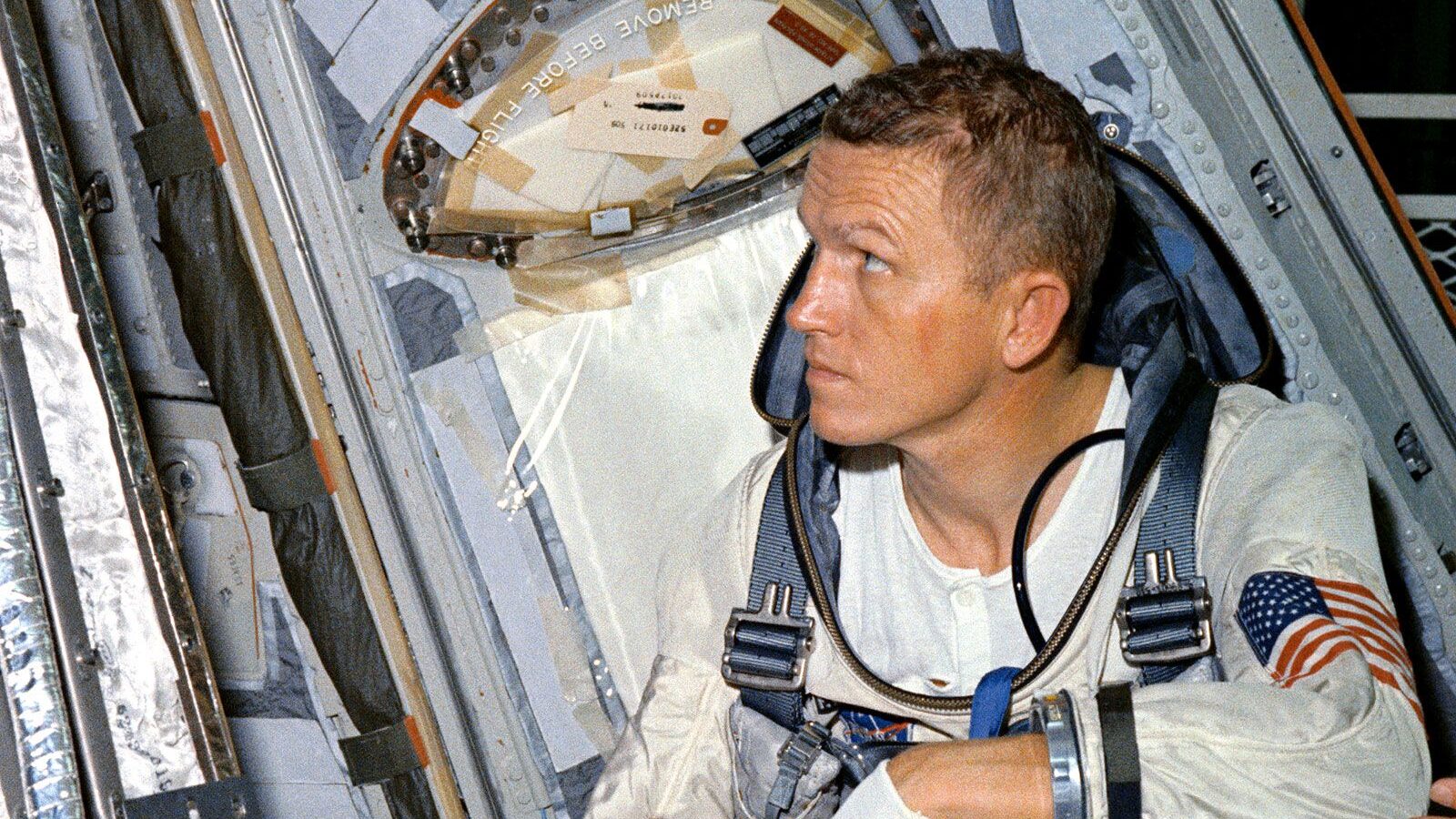 Astronaut Frank Borman, command pilot for the Gemini-7 spaceflight, looks over the Gemini-7 spacecr...