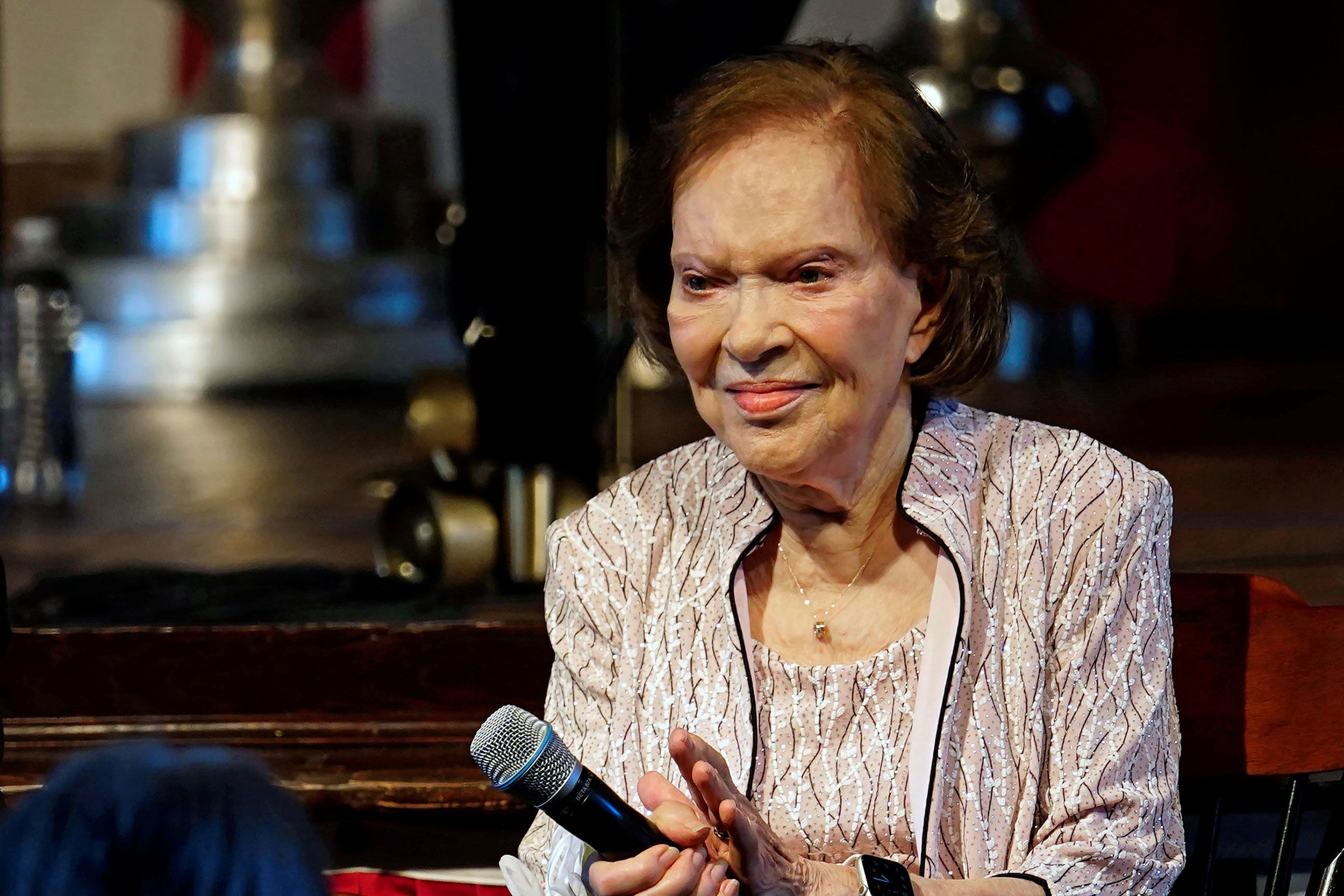 Former first lady Rosalynn Carter sits a reception to celebrate her and former President Jimmy Cart...