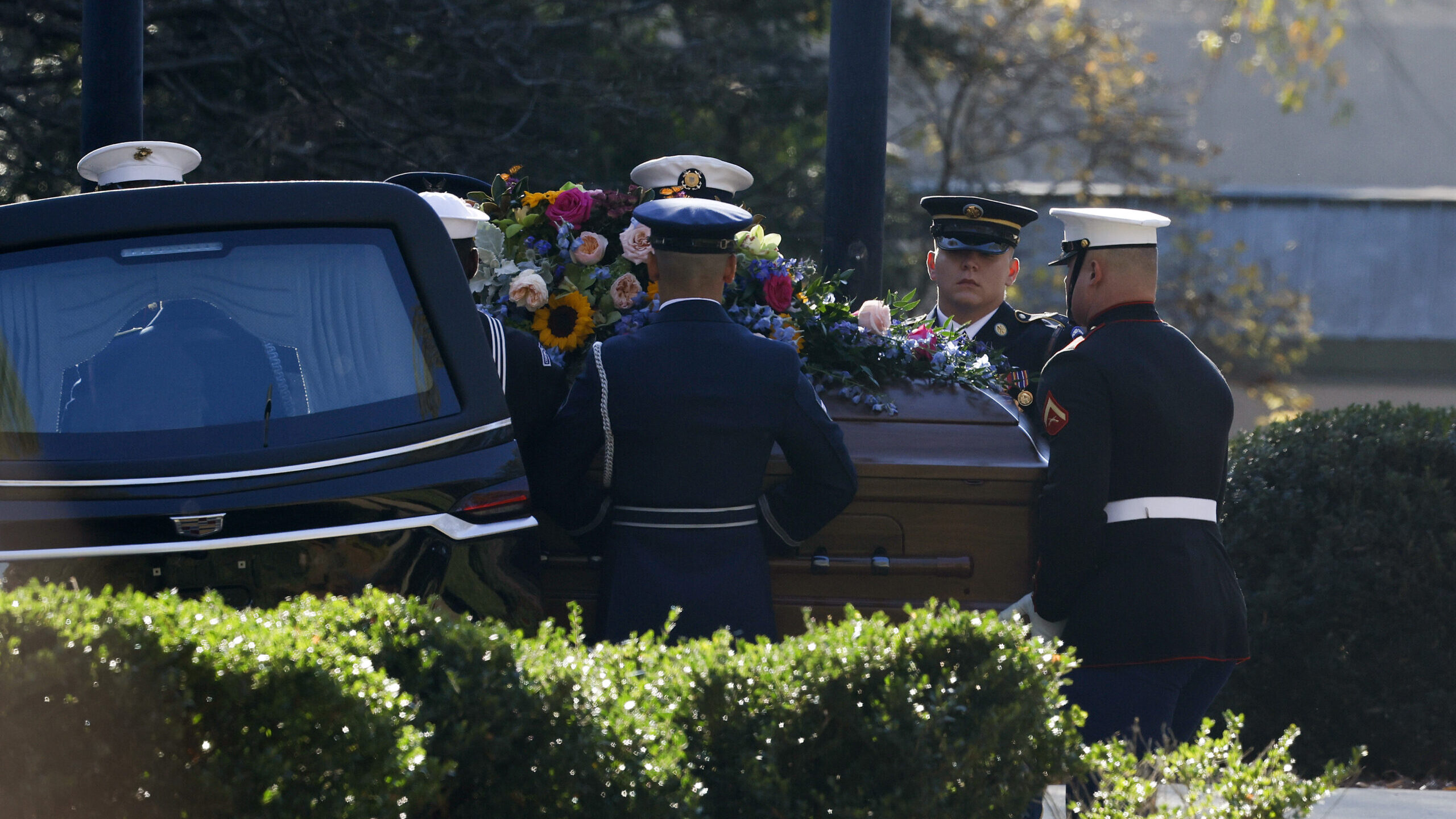 Honor Guard members carry a casket with the remains former first lady Rosalynn Carter out of a hear...