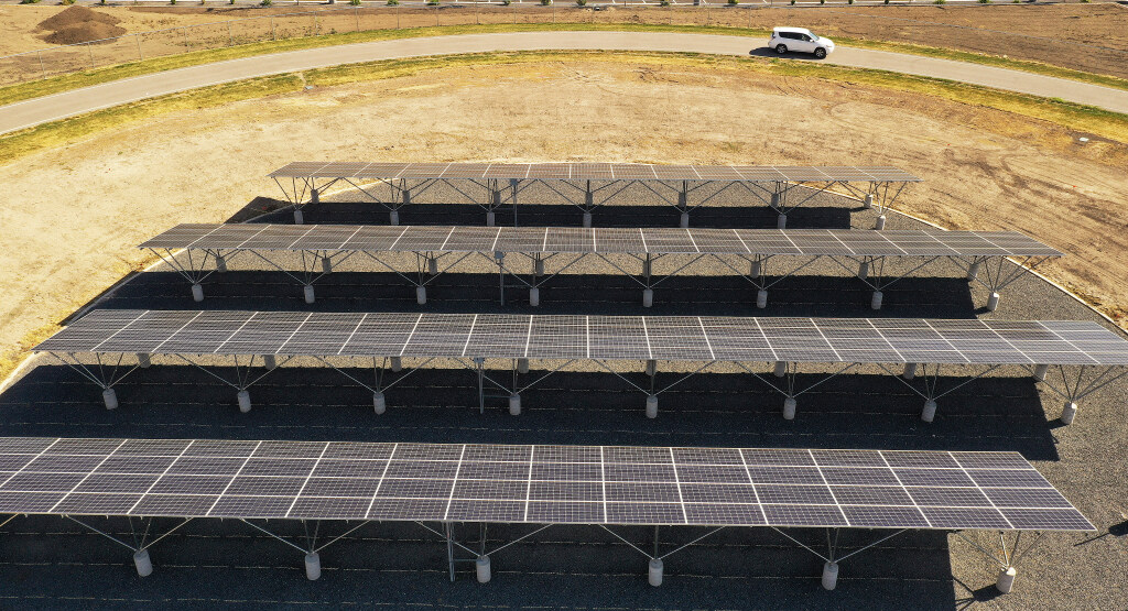 Solar panels fuel a track equipped with power transfer coils embedded in the roadway, enabling prop...