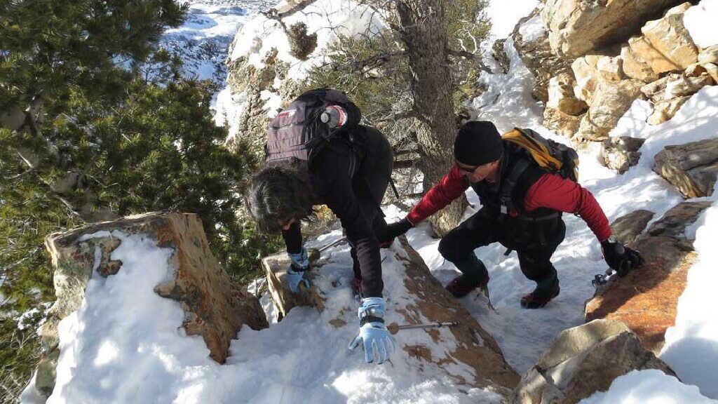 Hikers ascend a snowy chute. This is an example of the winter activities available for outdoor enth...