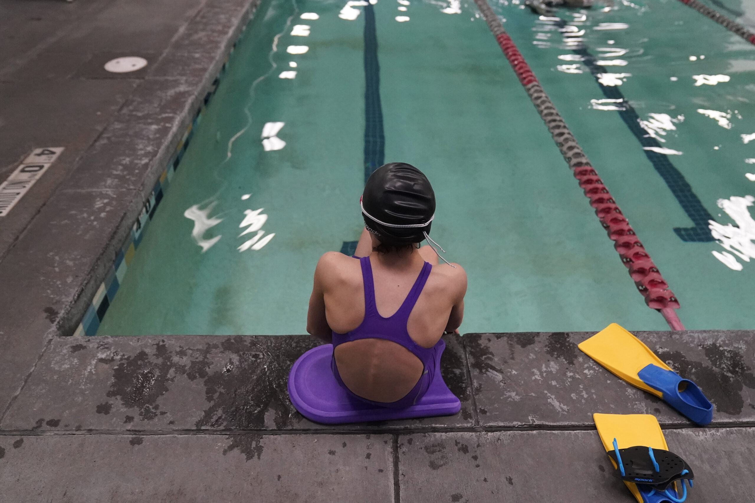 FILE - A 12-year-old transgender swimmer is seen waiting by a pool, Feb. 22, 2021, in Utah. She and...