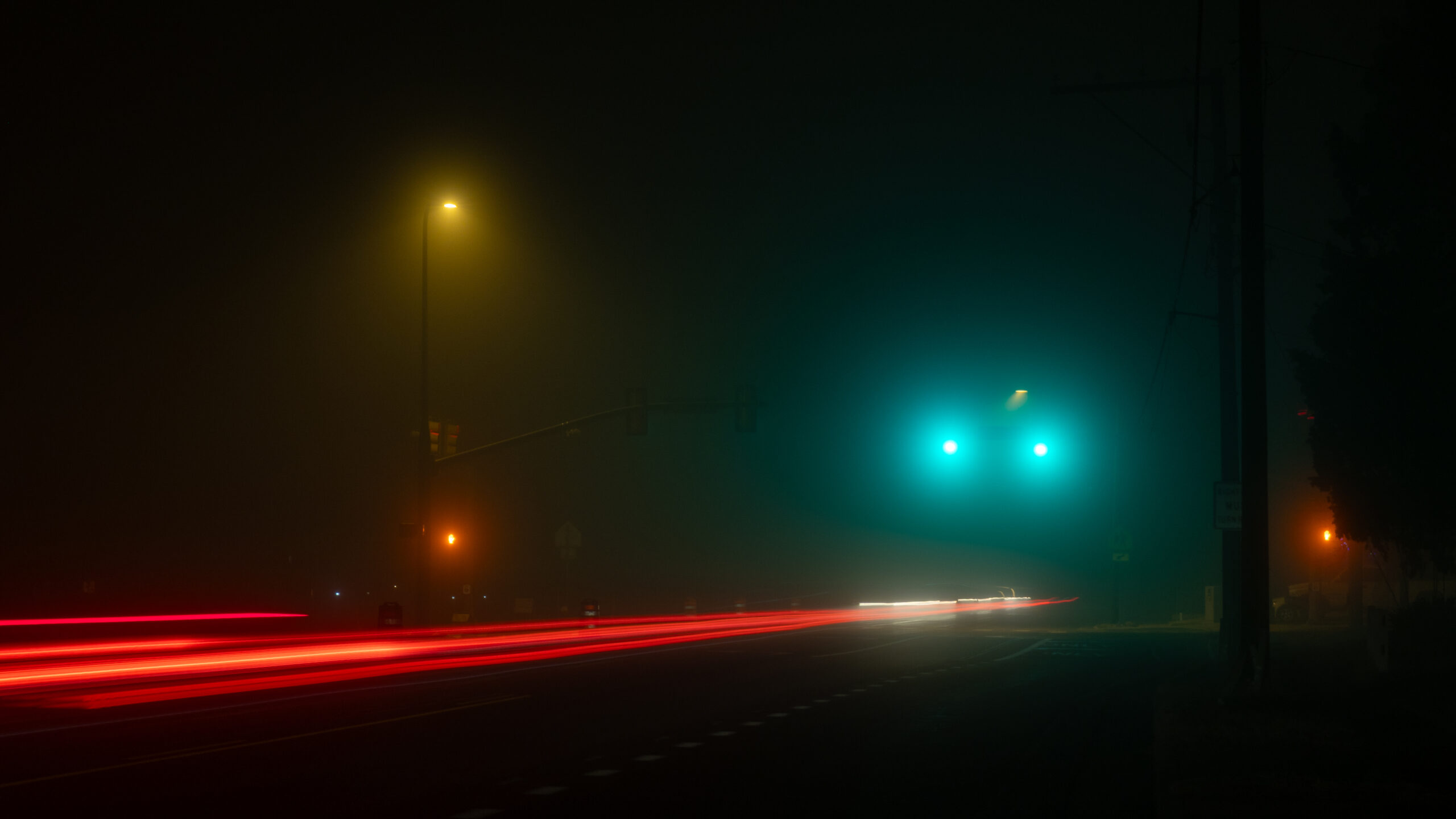 Cars driving in the fog late at night in Roy, Utah...