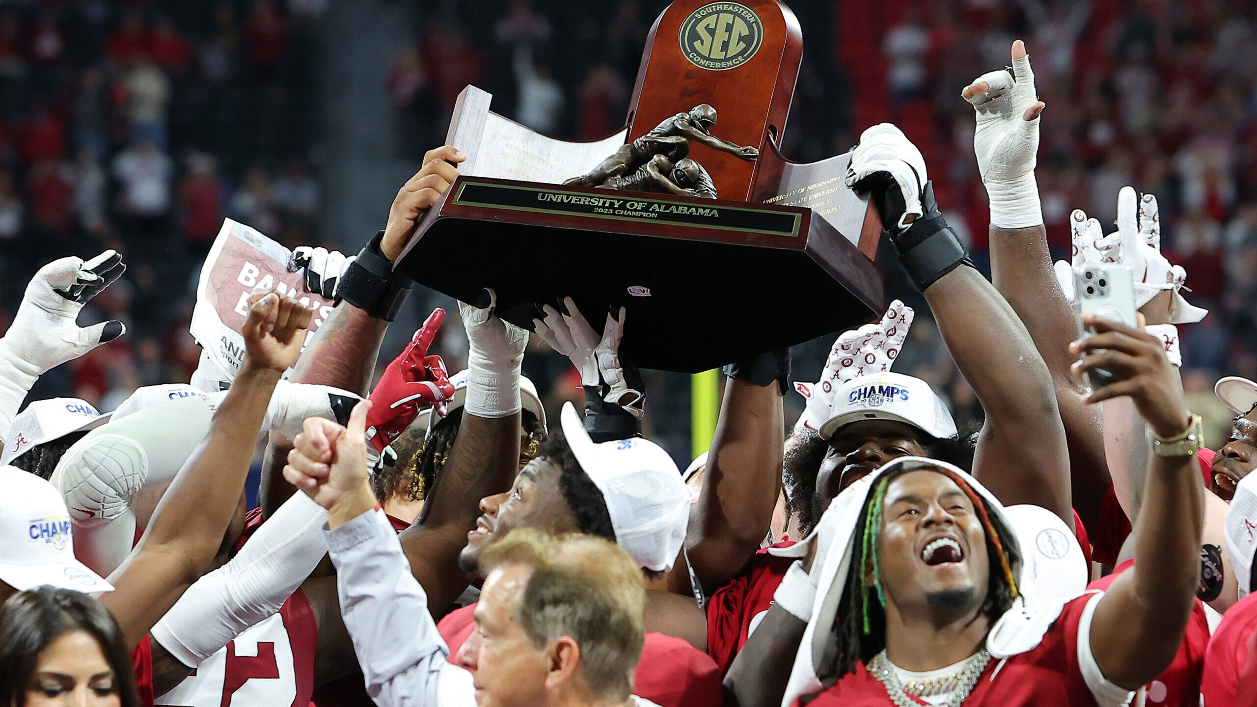 The Alabama Crimson Tide celebrate with the SEC Championship trophy after defeating the Georgia Bul...
