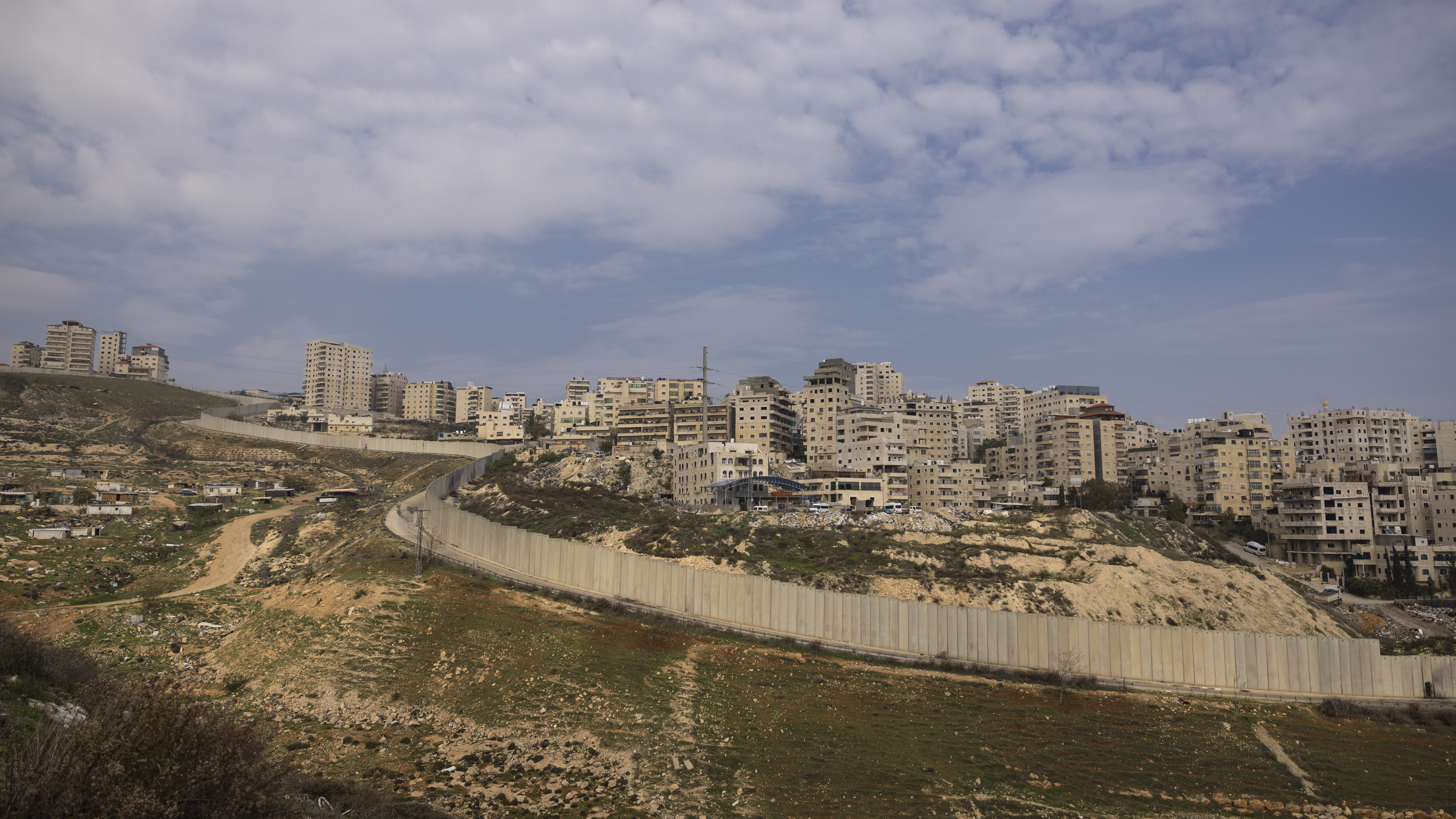 The Israeli separation wall is seen in the outskirts of the East Jerusalem refugee camp of Shuafat ...