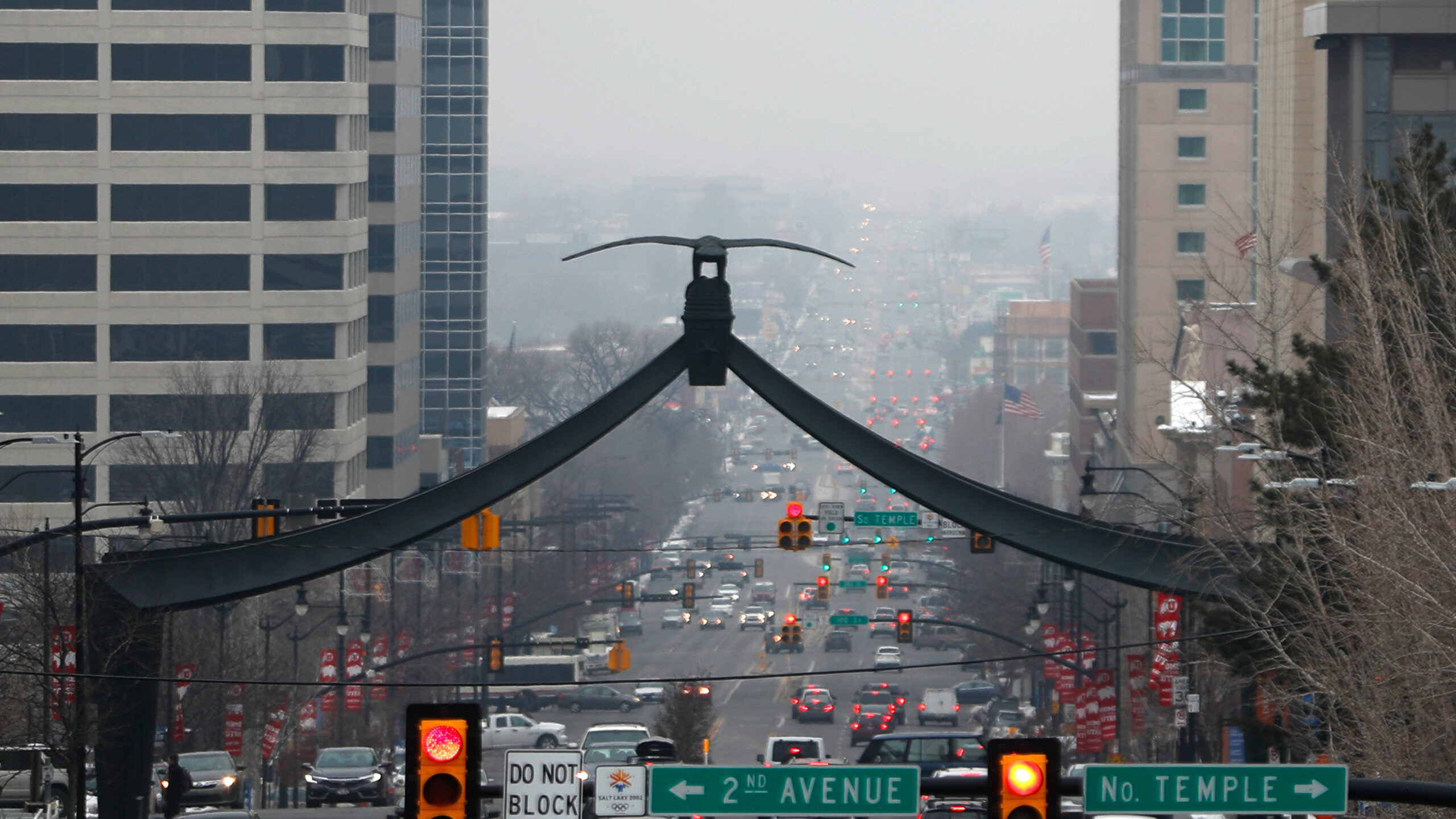 Cars make their way up and down State Street as a temperature inversion traps and fills downtown Sa...