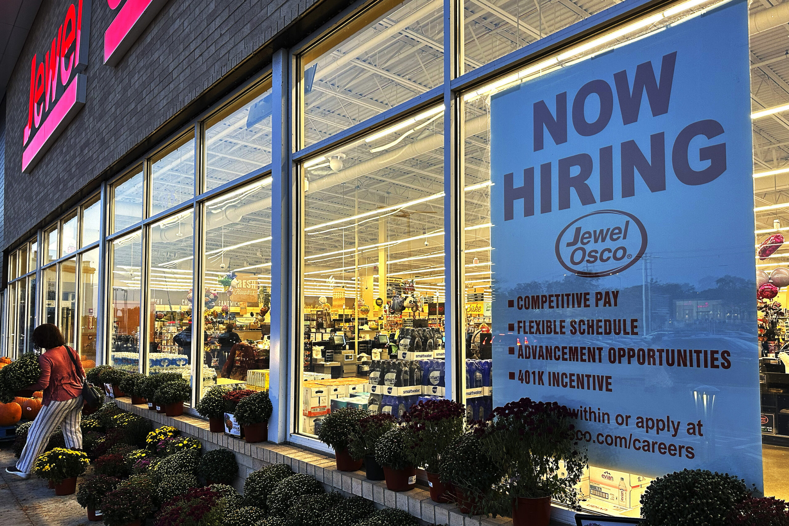 FILE - A hiring sign is displayed at a grocery store, Oct. 5, 2023, in Deerfield, Ill. Most busines...