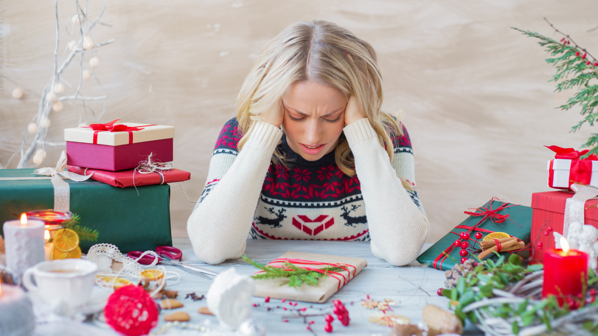 A person stares at a holiday decorated table, stressed....