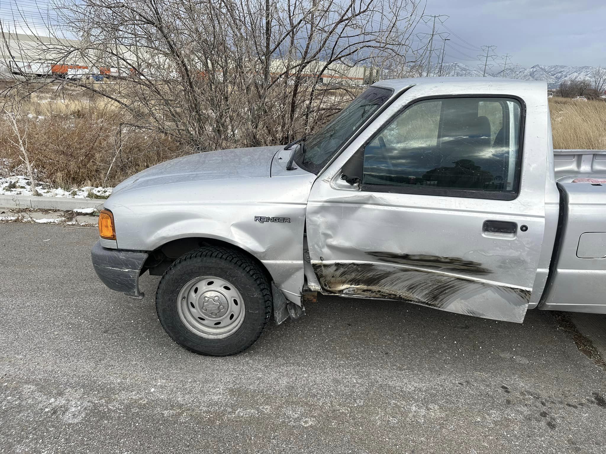 Silver truck with door damage from road rage crash....