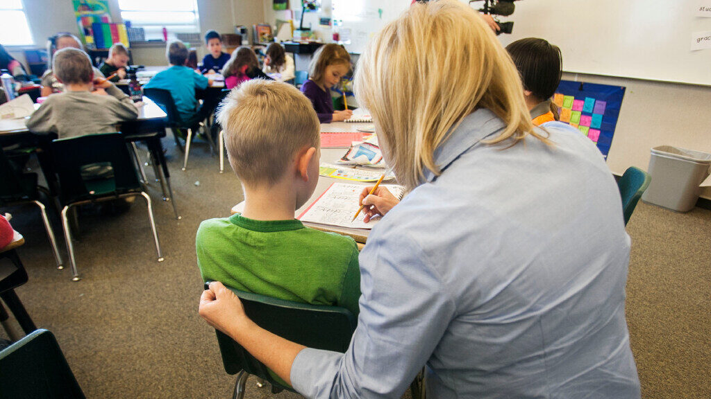 Teacher Stacey Johnsen works with her students at Daybreak Elementary Monday, Feb. 25, 2013....