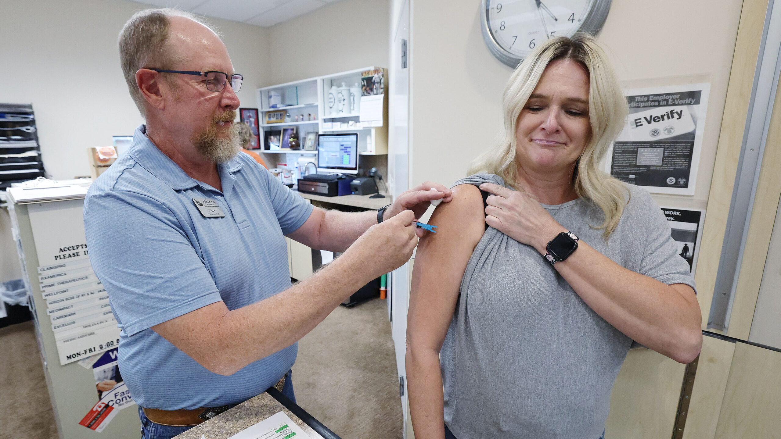 FILE: Pharmacist Tad Jolley vaccinates gift shop employee Kamie White with a flu shot at Jolley’s...
