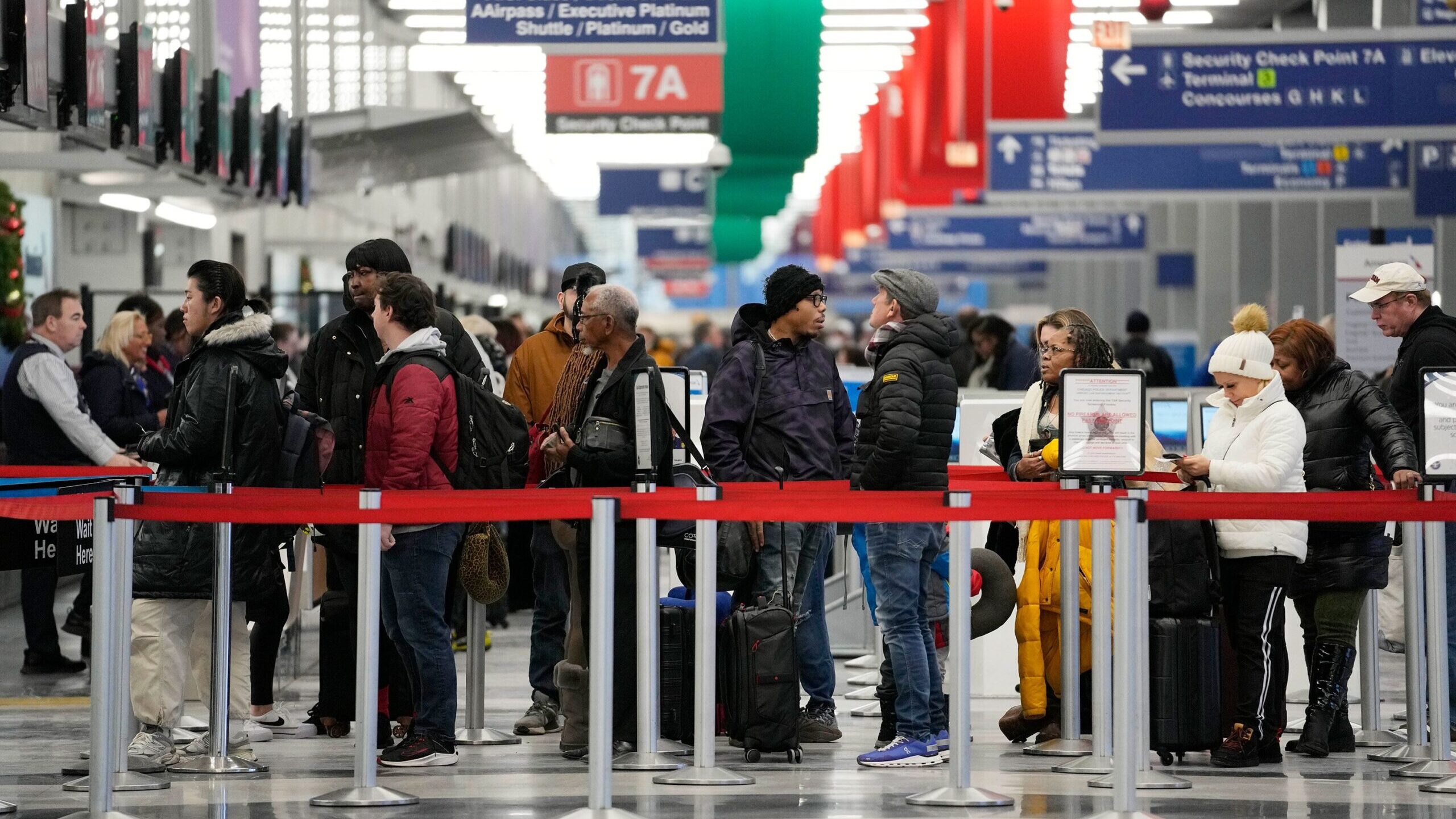 Travelers wait to go through security check point at the O'Hare International Airport in Chicago, S...