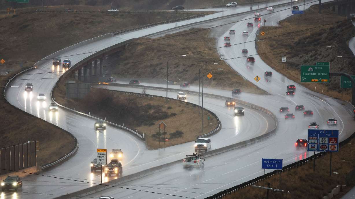 Motorists drive in the rain in Millcreek on Feb. 7. Mountain snow and valley rain are back in Utah'...