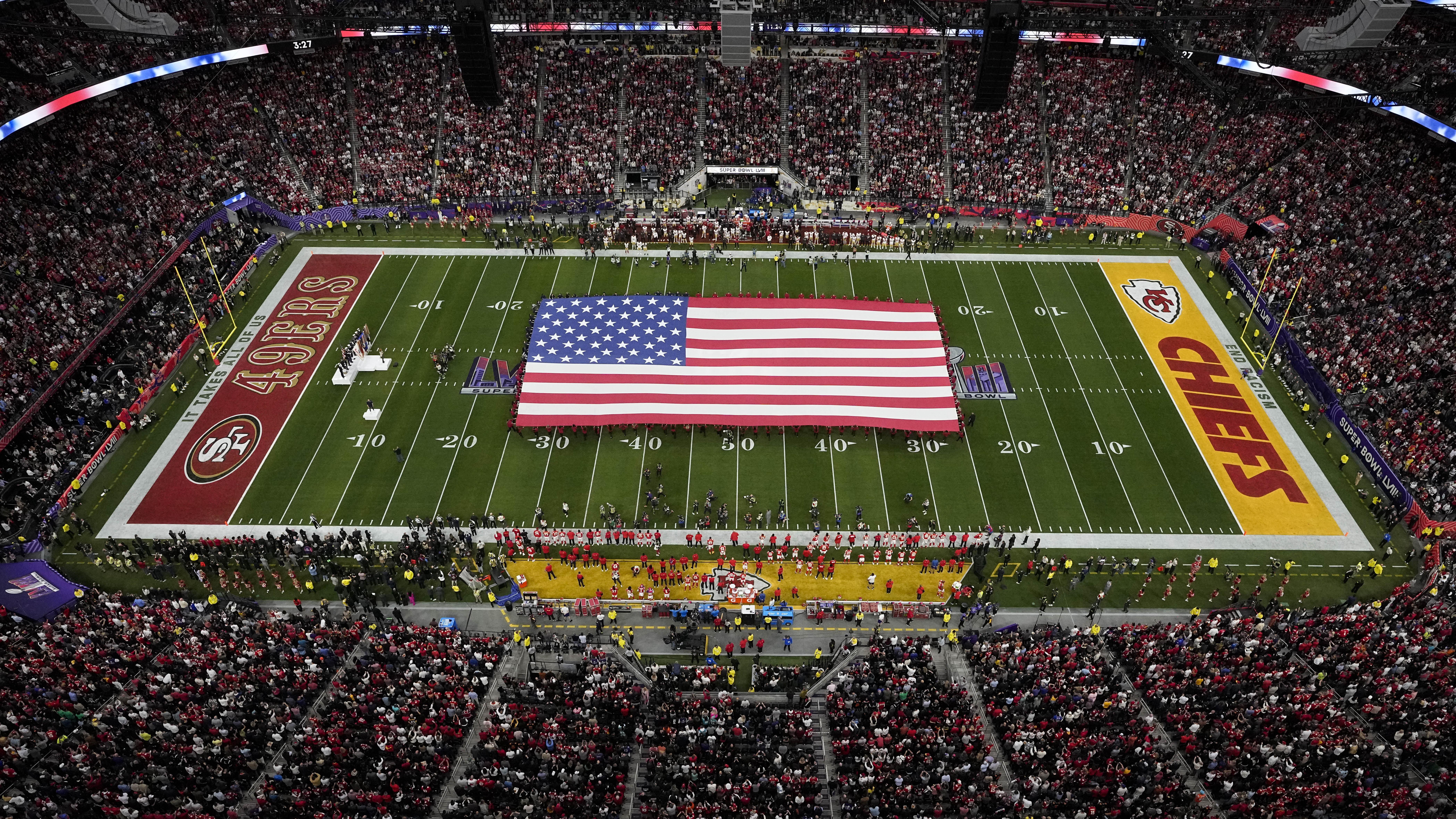 giant flag at super bowl while national anthem is sung...