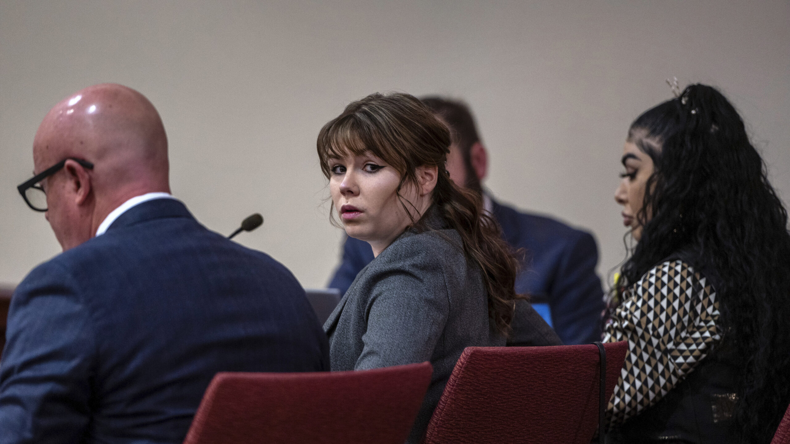 Hannah Gutierrez-Reed, center, sits with her attorney Jason Bowles, left, during the first day of t...