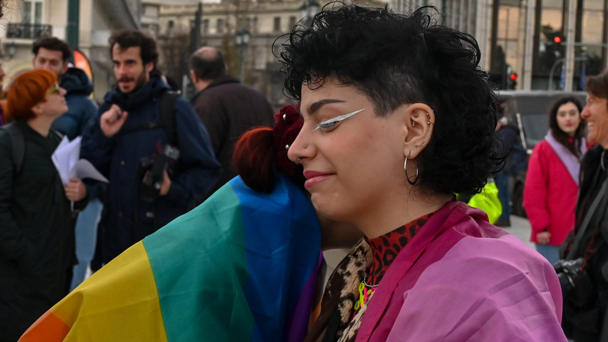 People react as supporters of the bill which legalizes same-sex civil marriage gather in front of t...