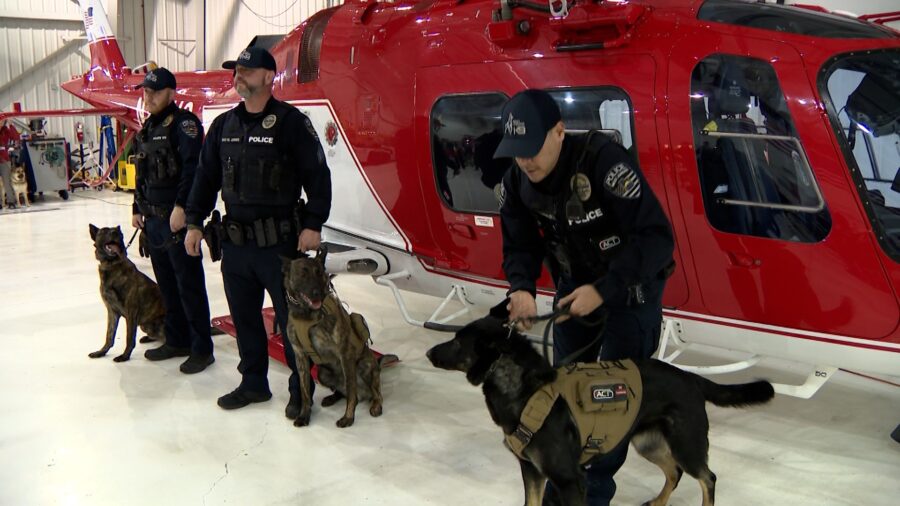 K9 officers stand with police dogs next to a Life Flight Helicopter. A new program by Intermountain...