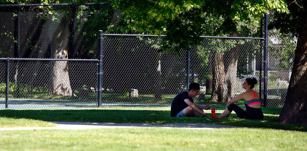 Shane Romano and Sami Sowers take a rest in the shade at Sunnyside Park in Salt Lake City, Tuesday,...