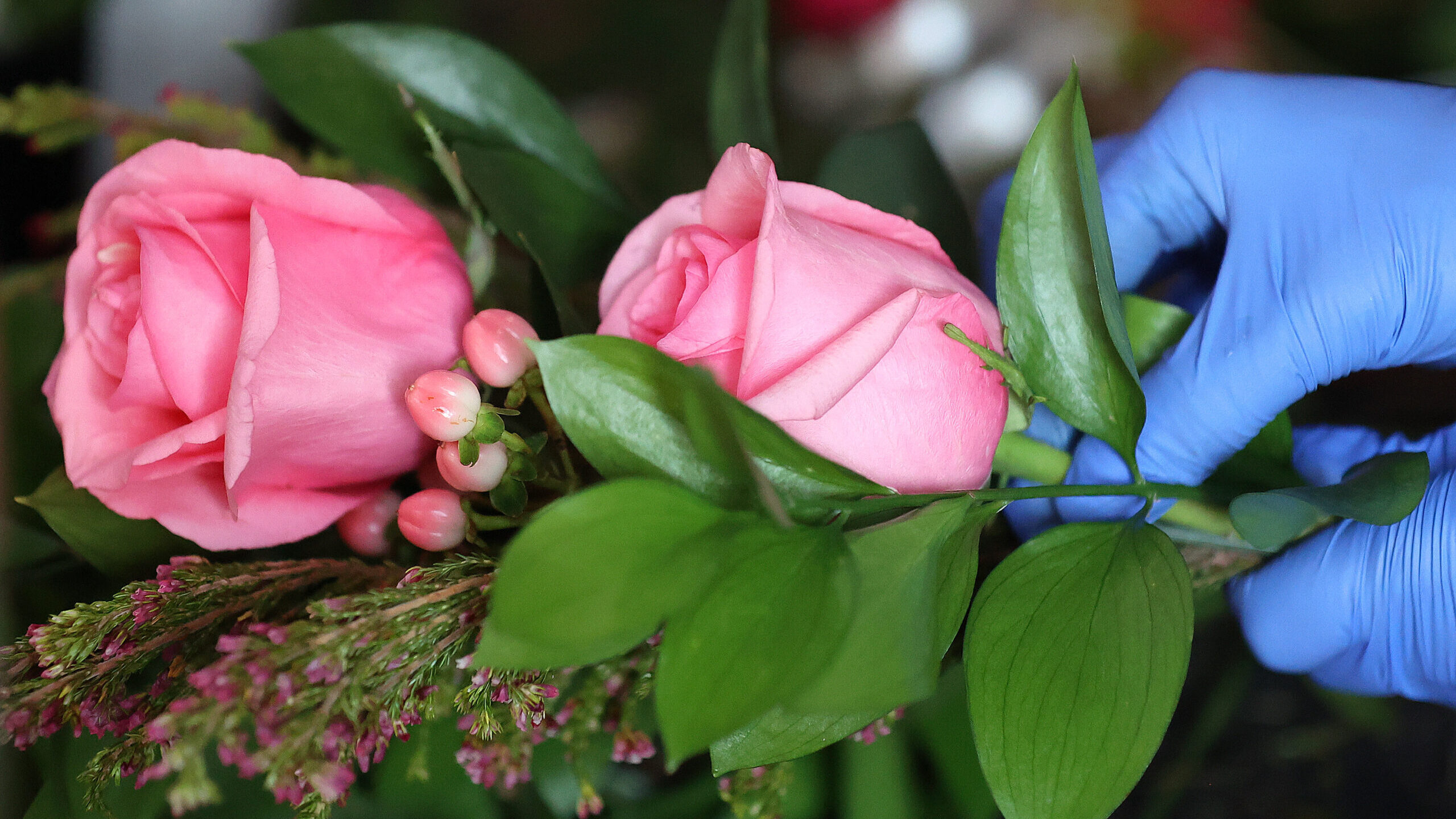 A florist makes a Valentine’s Day floral arrangement at Flower Imagination in Salt Lake City, on ...