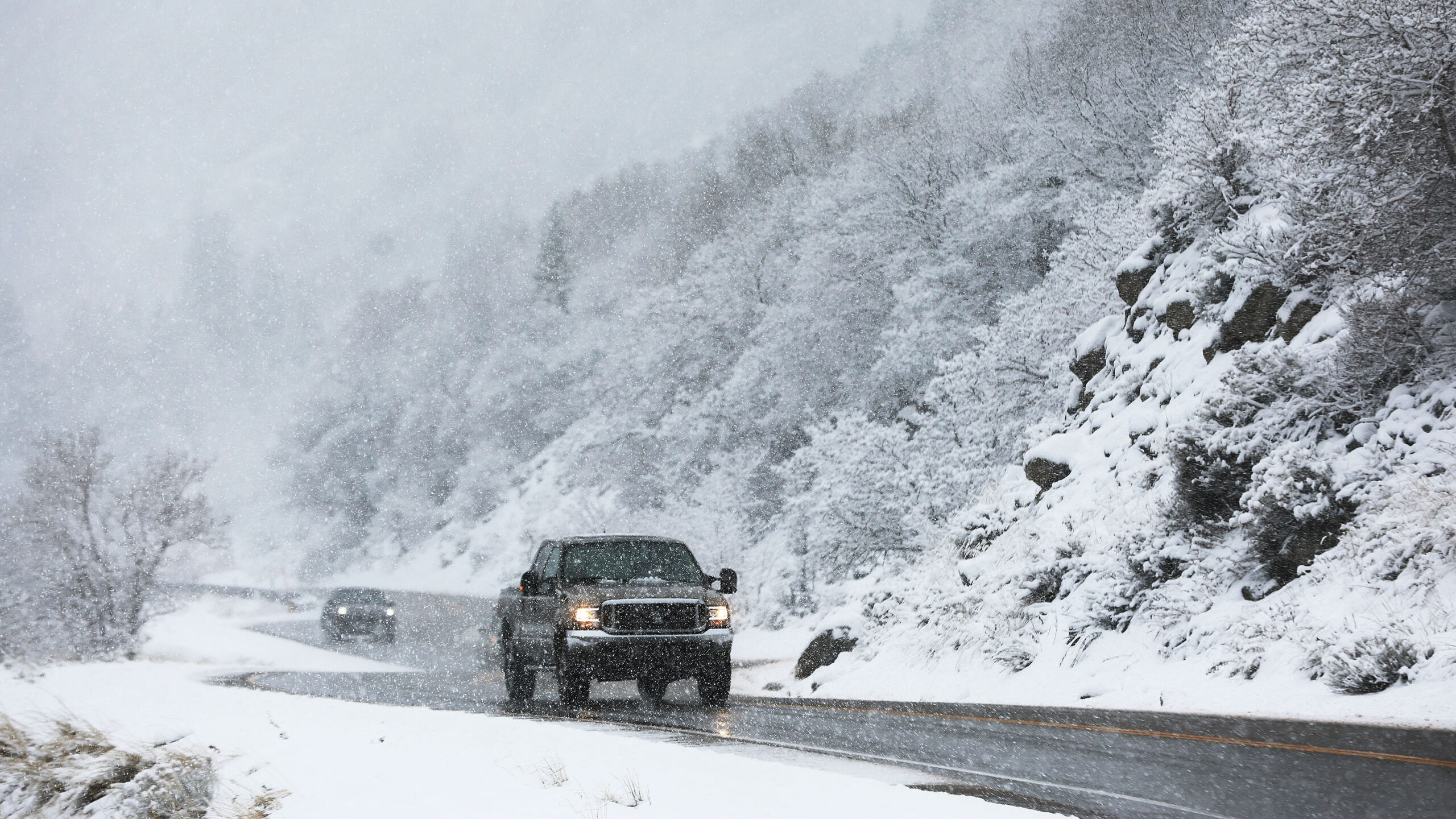 Motorists drive through falling snow in Little Cottonwood Canyon on Wednesday, Feb. 7, 2024. The Na...