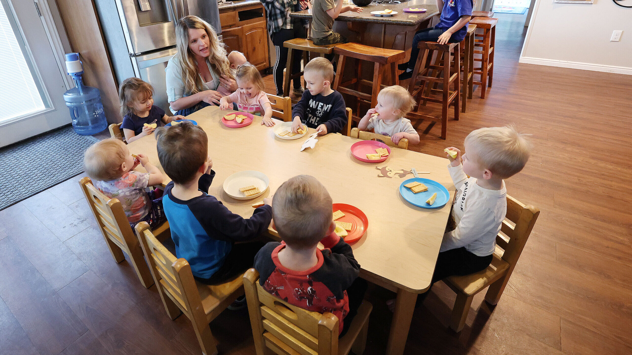 Child care provider Holly Kingston gives children a snack at her home in West Jordan on Friday, Jan...