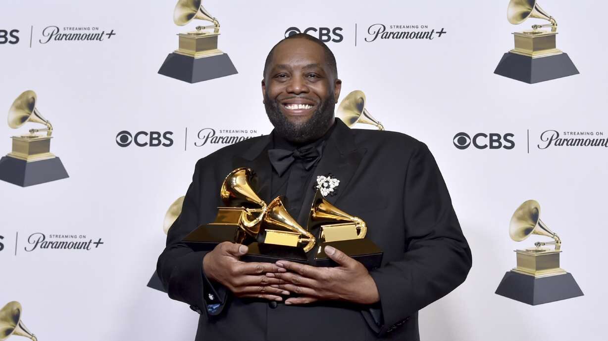 Killer Mike poses in the press room with three trophies he won at the 66th annual Grammy Awards on ...