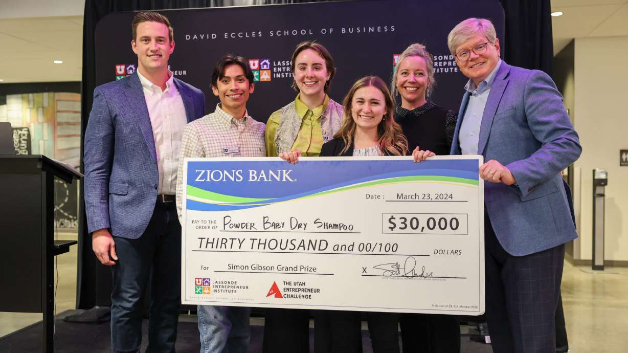 The Powder Baby Dry Shampoo team poses with its check after winning the 2024 Utah Entrepreneur Chal...