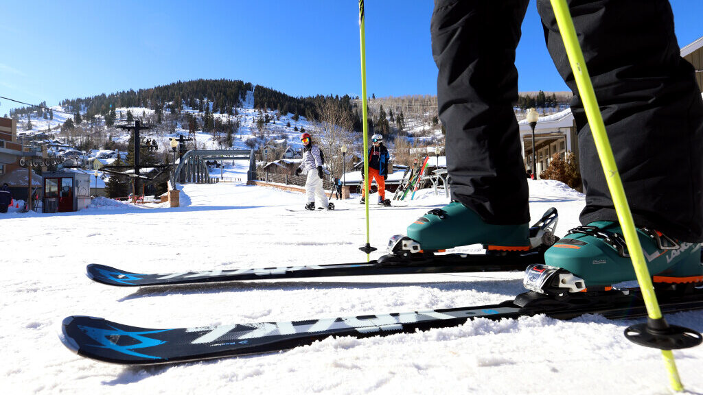 A skier makes their way toward the Town Lift on Main Street in Park City, Utah....