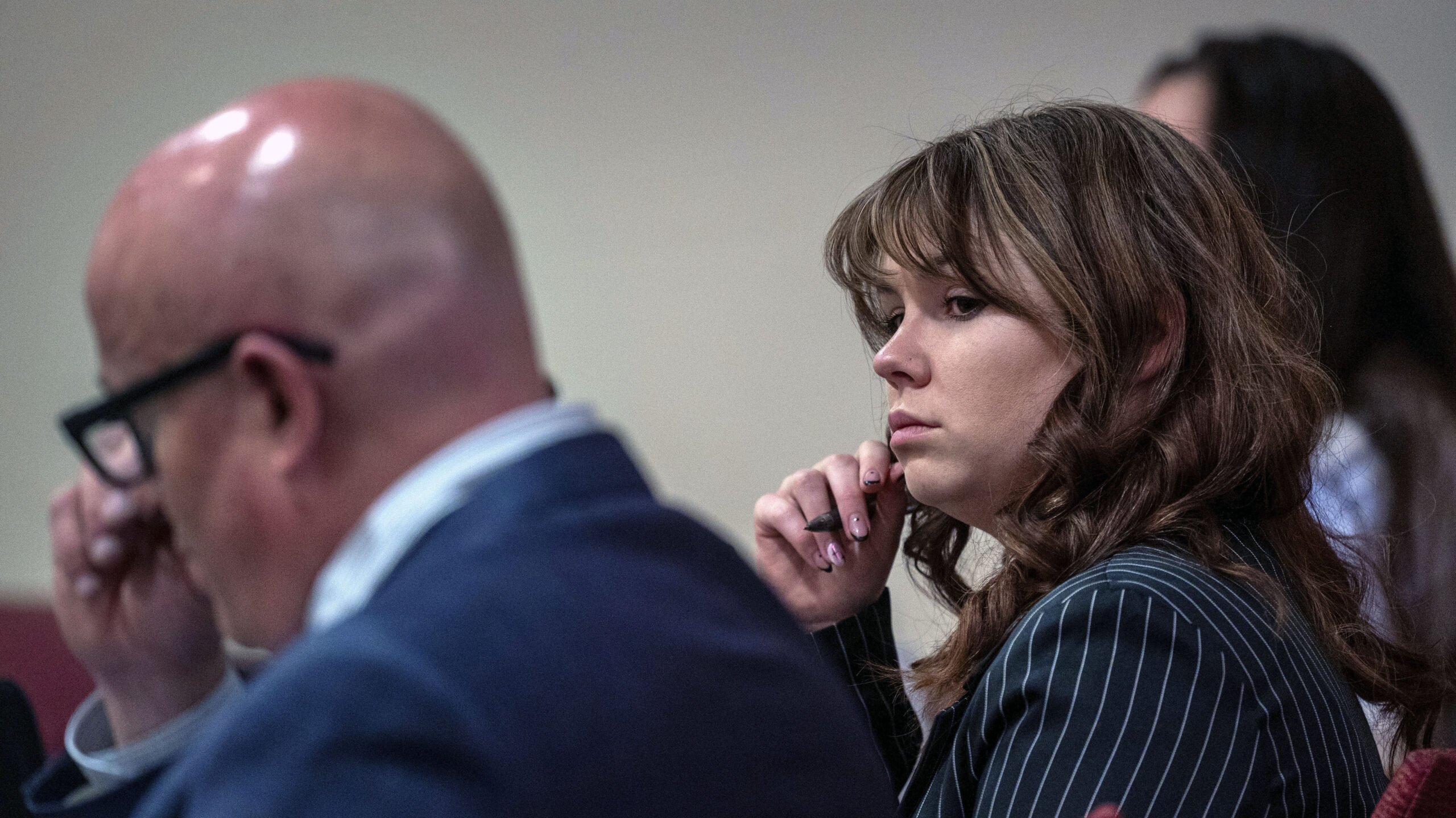 Hannah Gutierrez-Reed, center, sits with her attorney Jason Bowles, left, during testimony in the t...